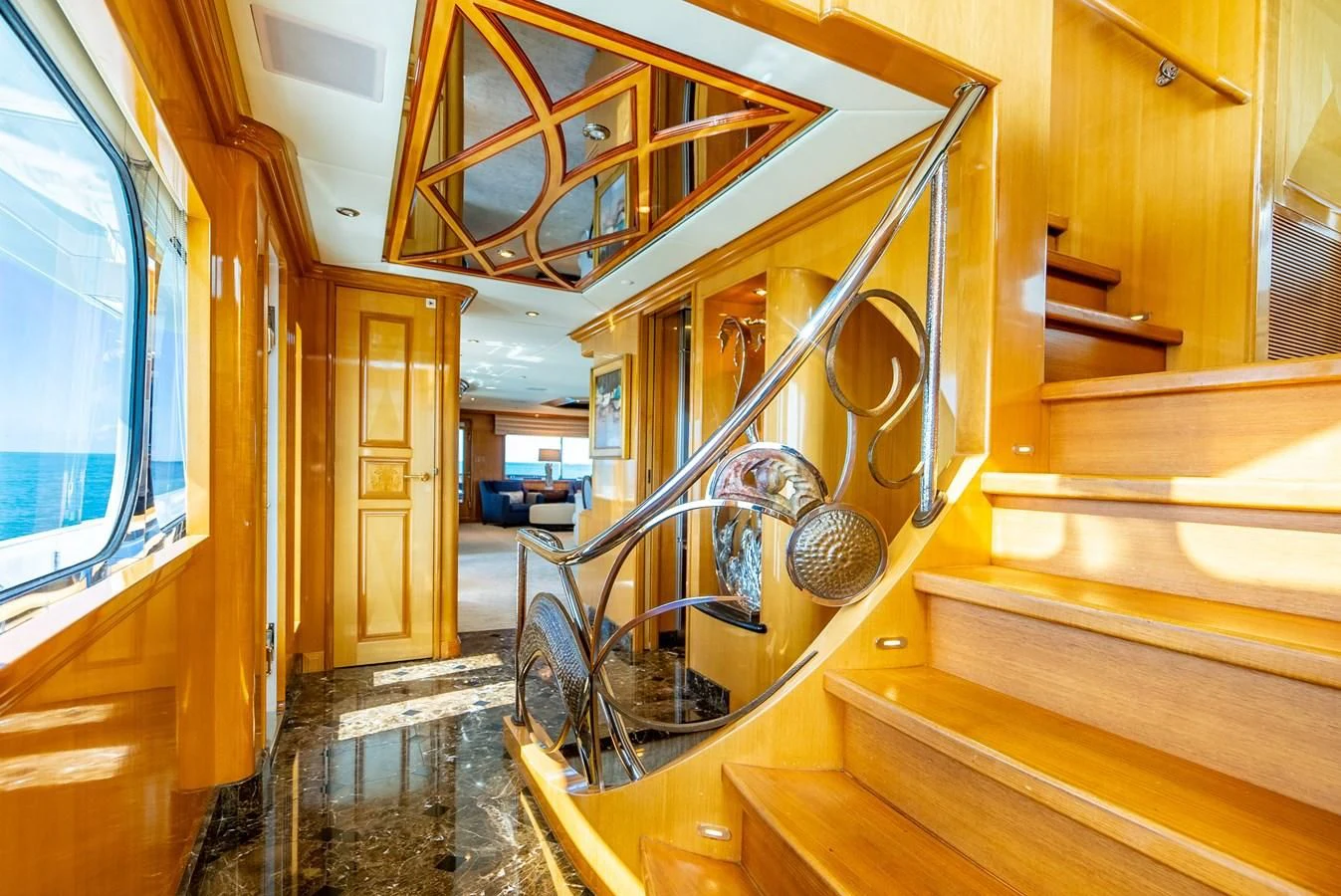 a large room with wood floors and a round fan aboard SEAQUEST Yacht for Sale