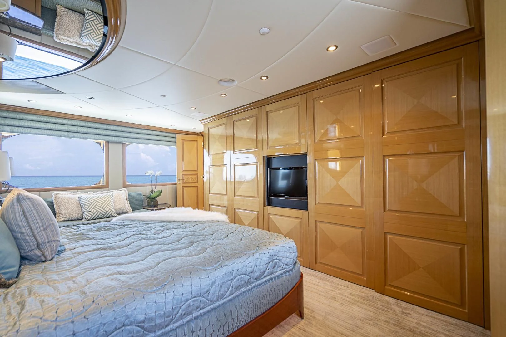 a bedroom with a bed and a tv aboard SEAQUEST Yacht for Sale
