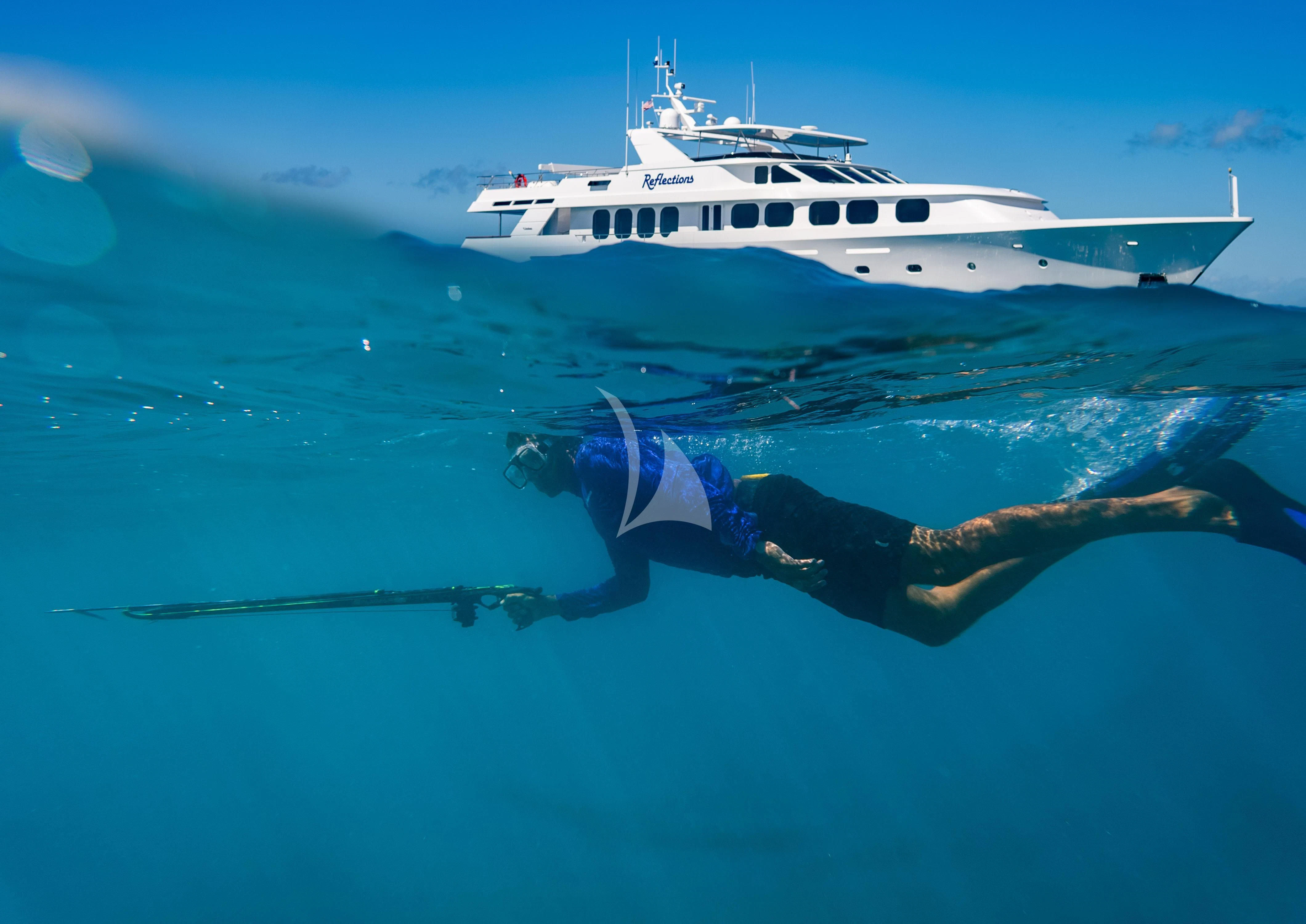 a person swimming in the water with a boat in the background aboard SEAQUEST Yacht for Sale
