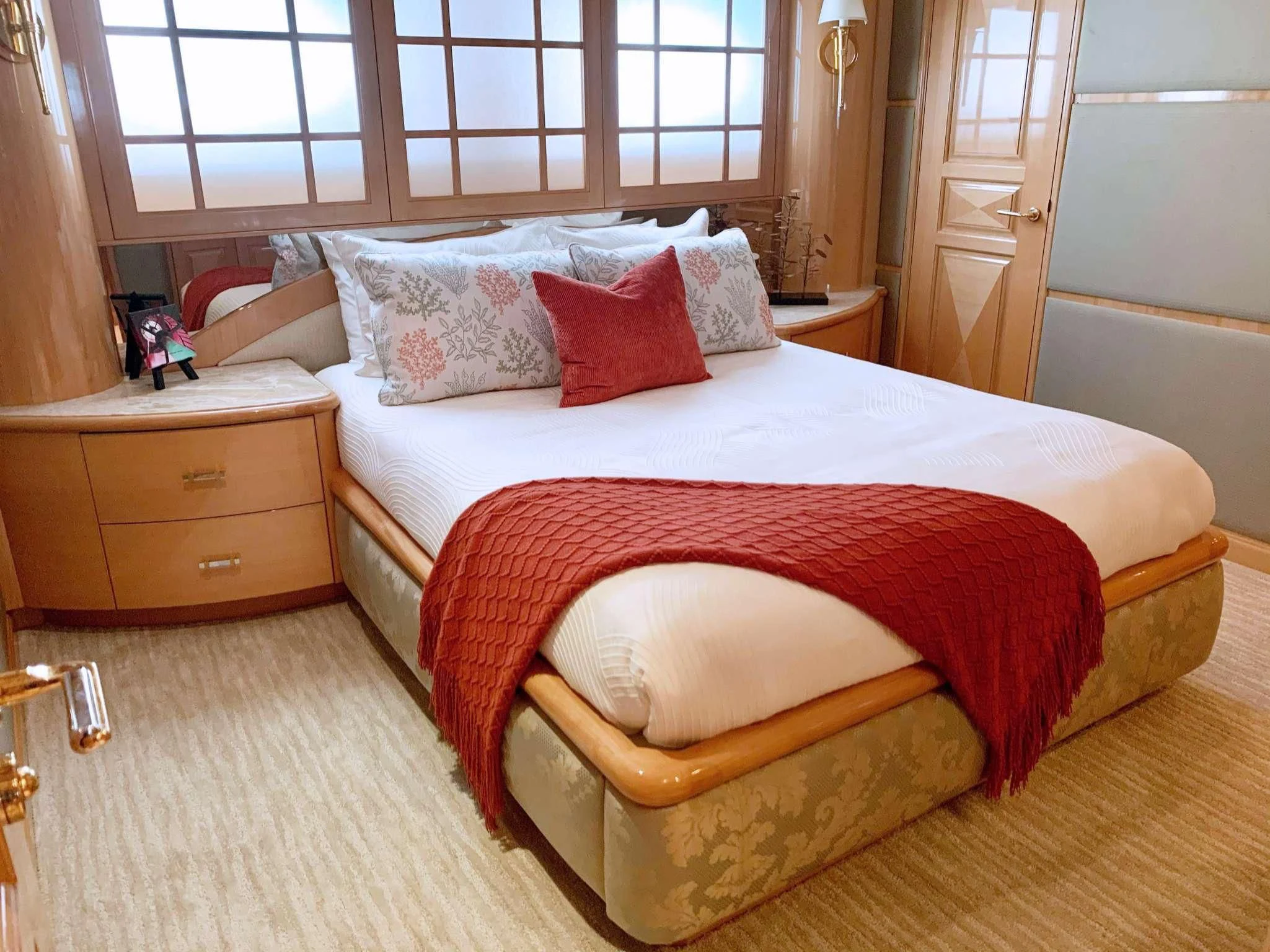 a bed with a red comforter aboard SEAQUEST Yacht for Sale