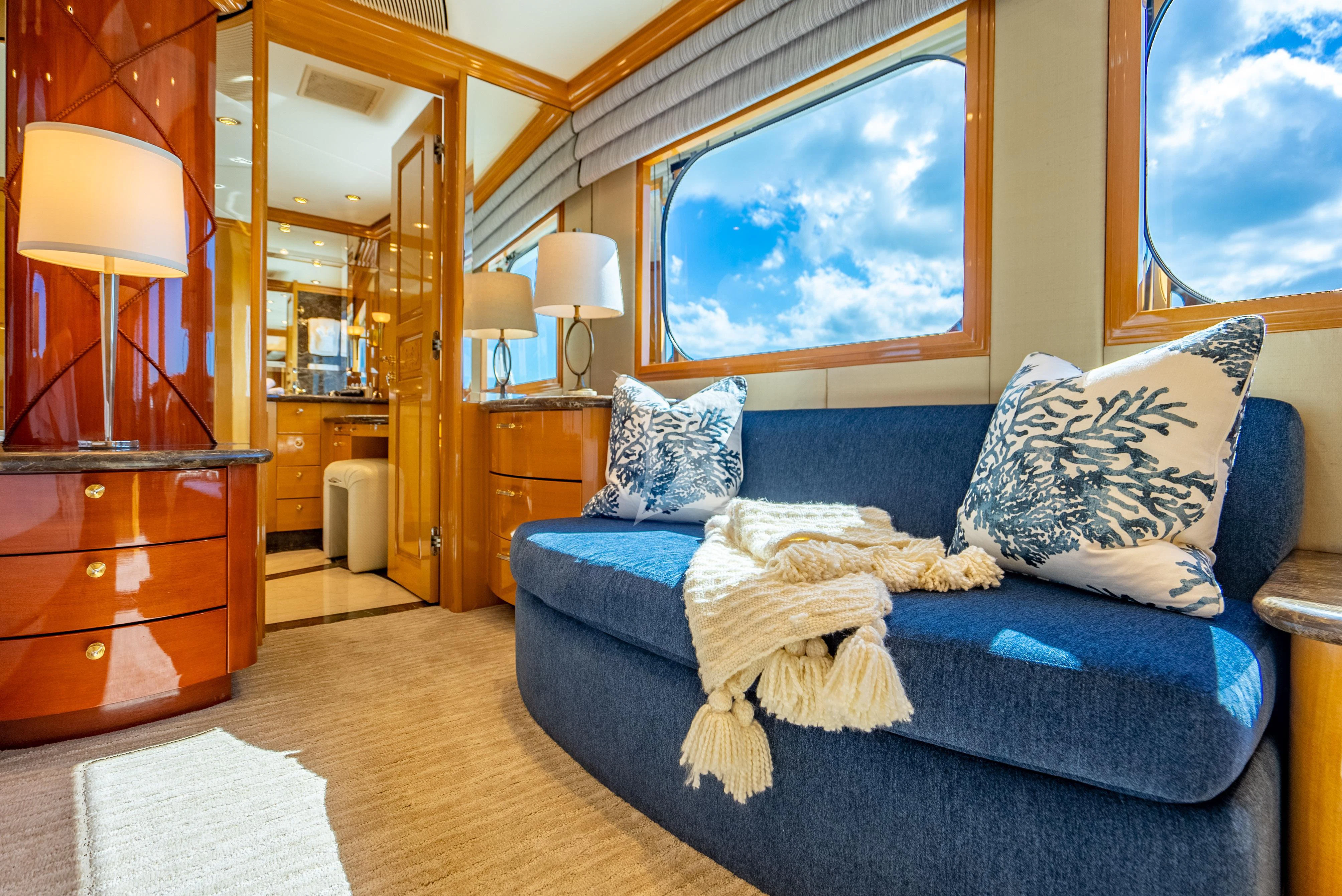 a bedroom with a bed and a mirror aboard SEAQUEST Yacht for Sale