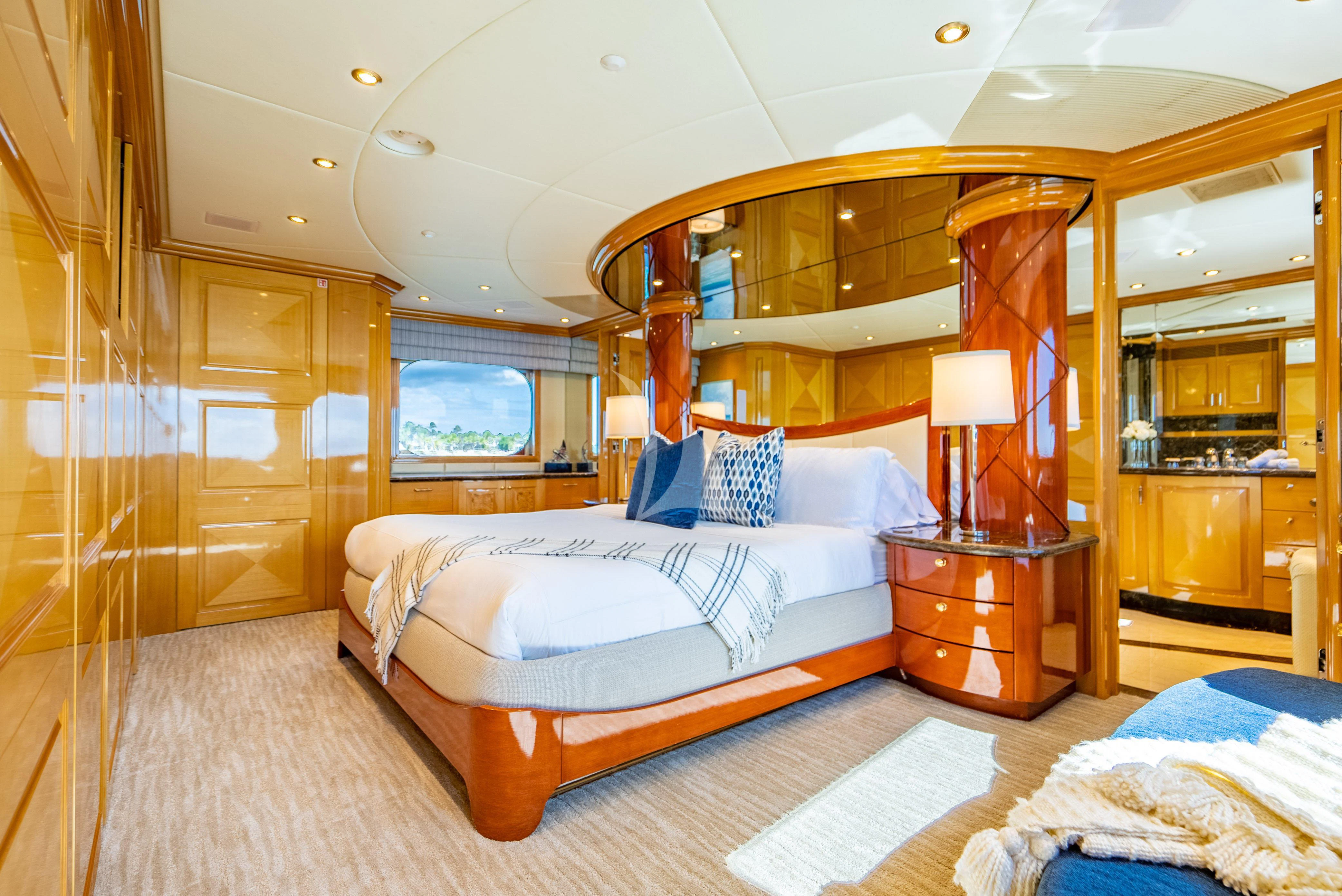 a bedroom with a bed and a mirror aboard SEAQUEST Yacht for Sale