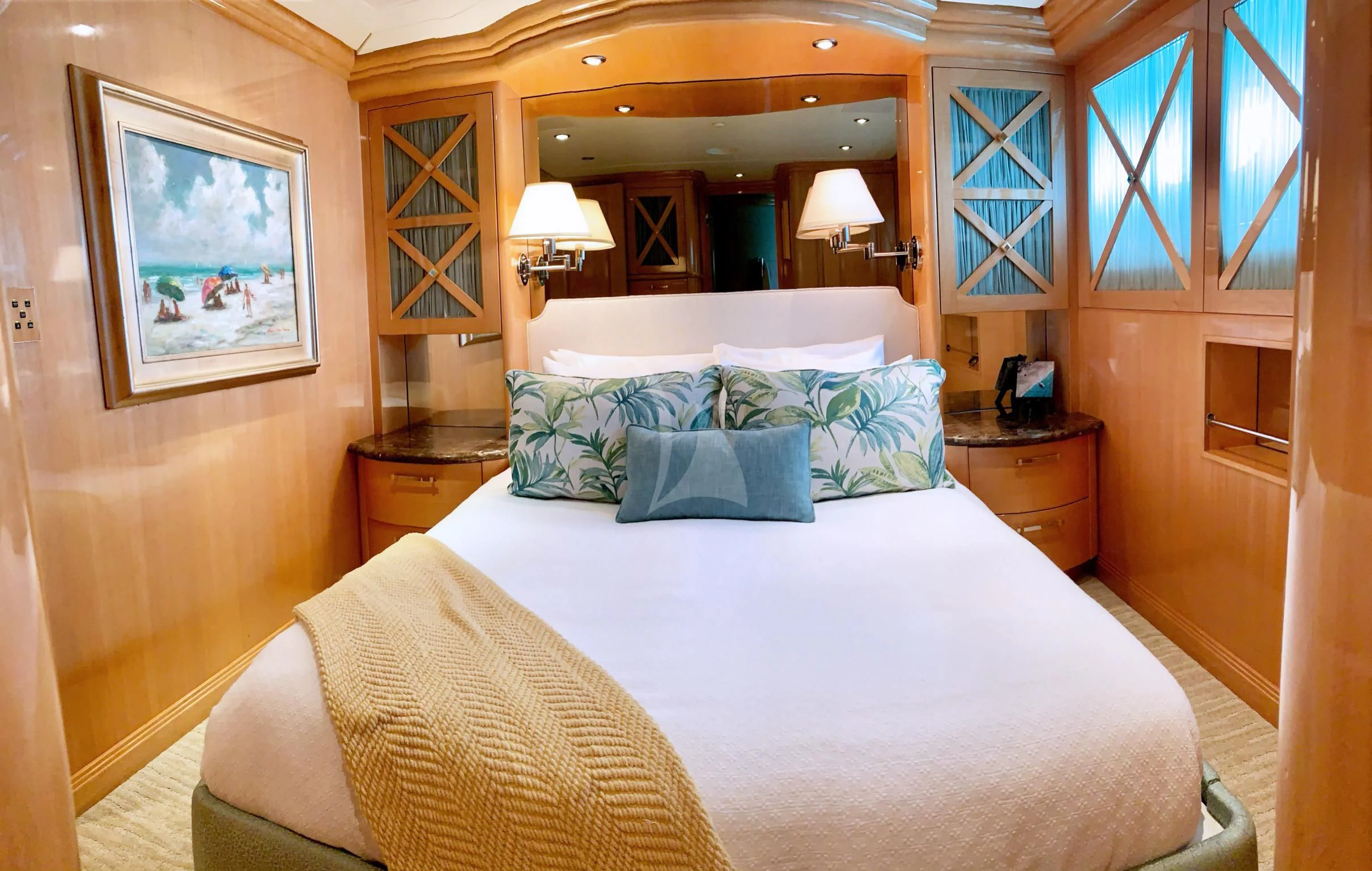 a bed with a white sheet and pillows in a room with a window aboard SEAQUEST Yacht for Sale