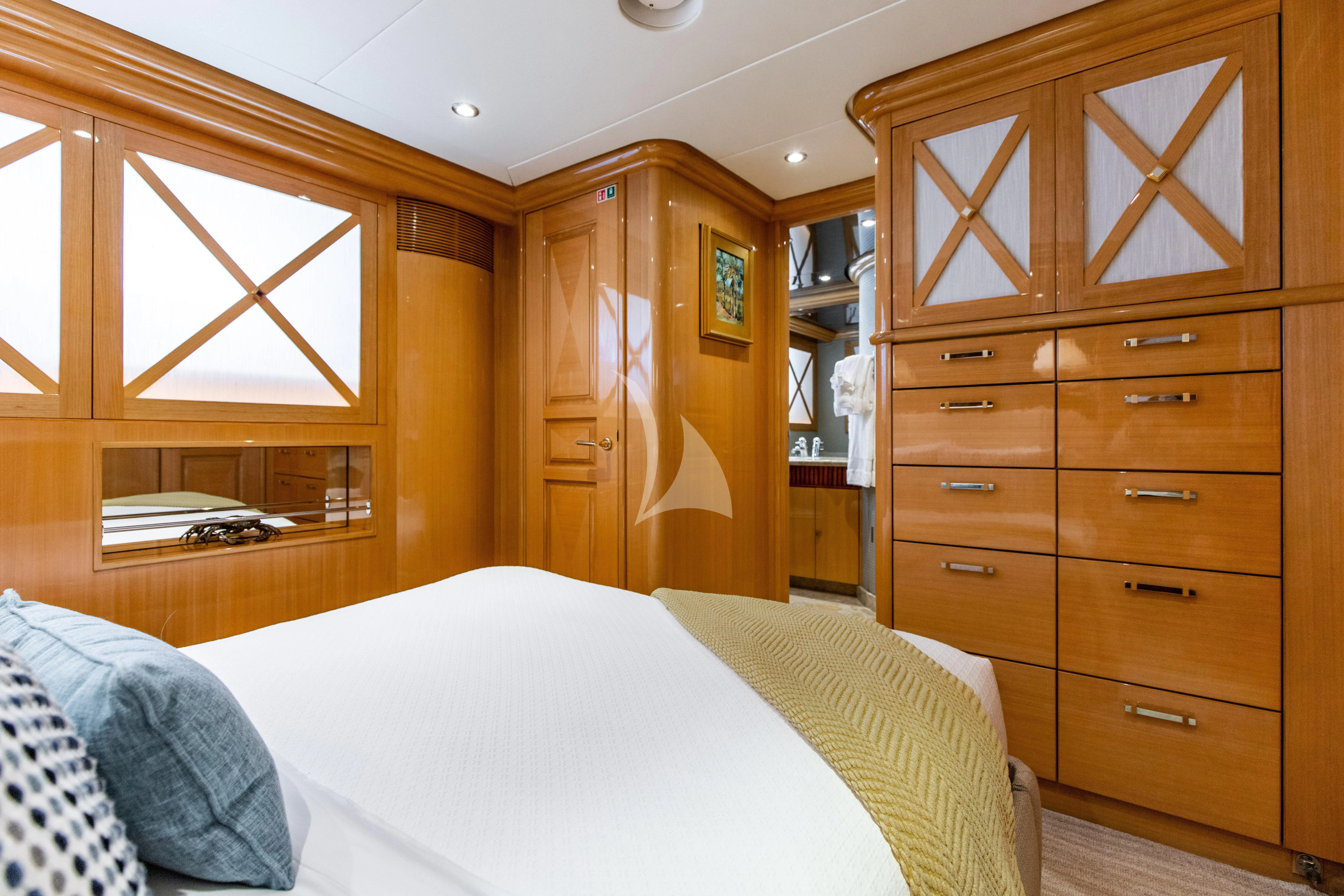 a bedroom with a bed and cabinets aboard SEAQUEST Yacht for Sale
