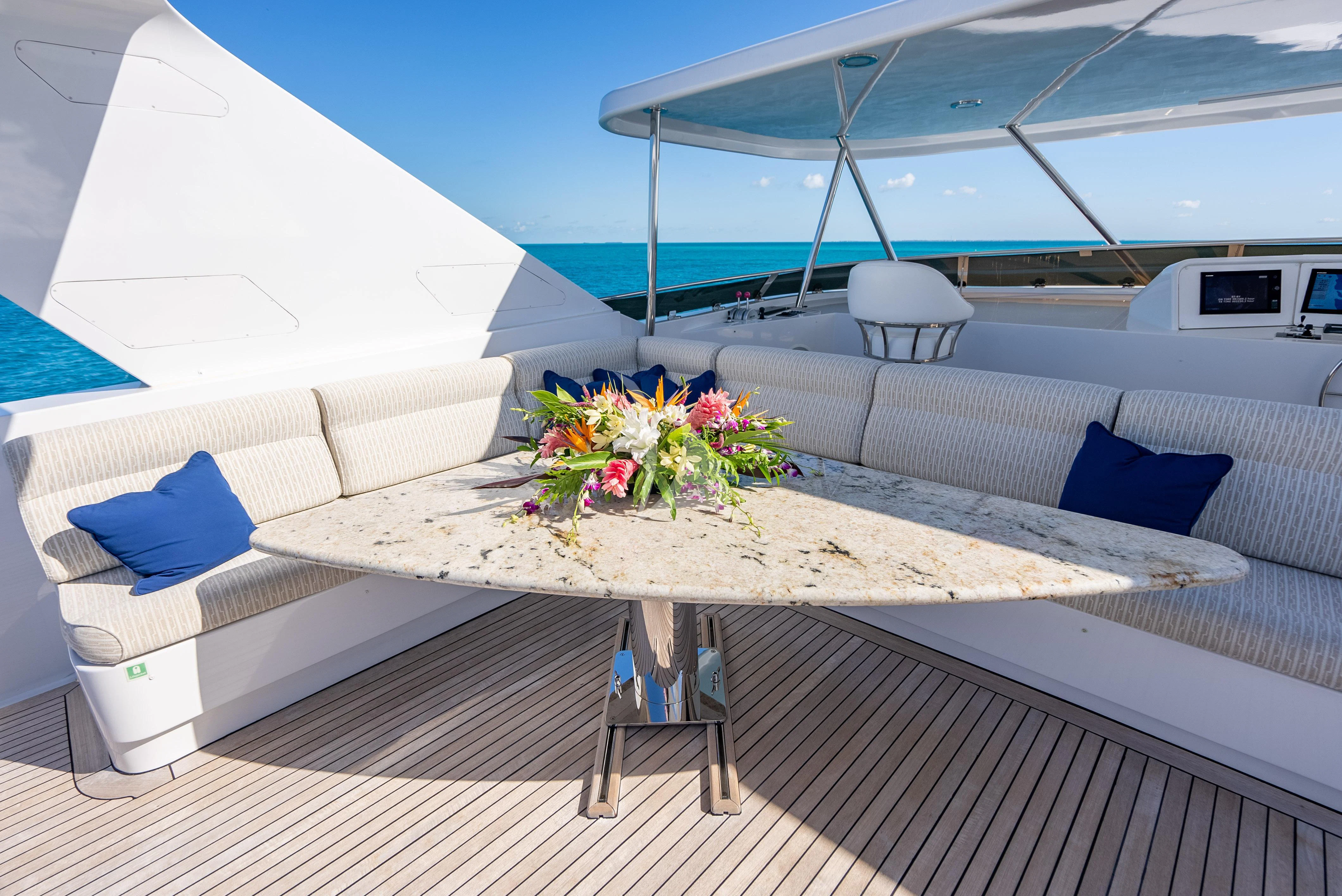 a white couch with a table and chairs on it aboard SEAQUEST Yacht for Sale