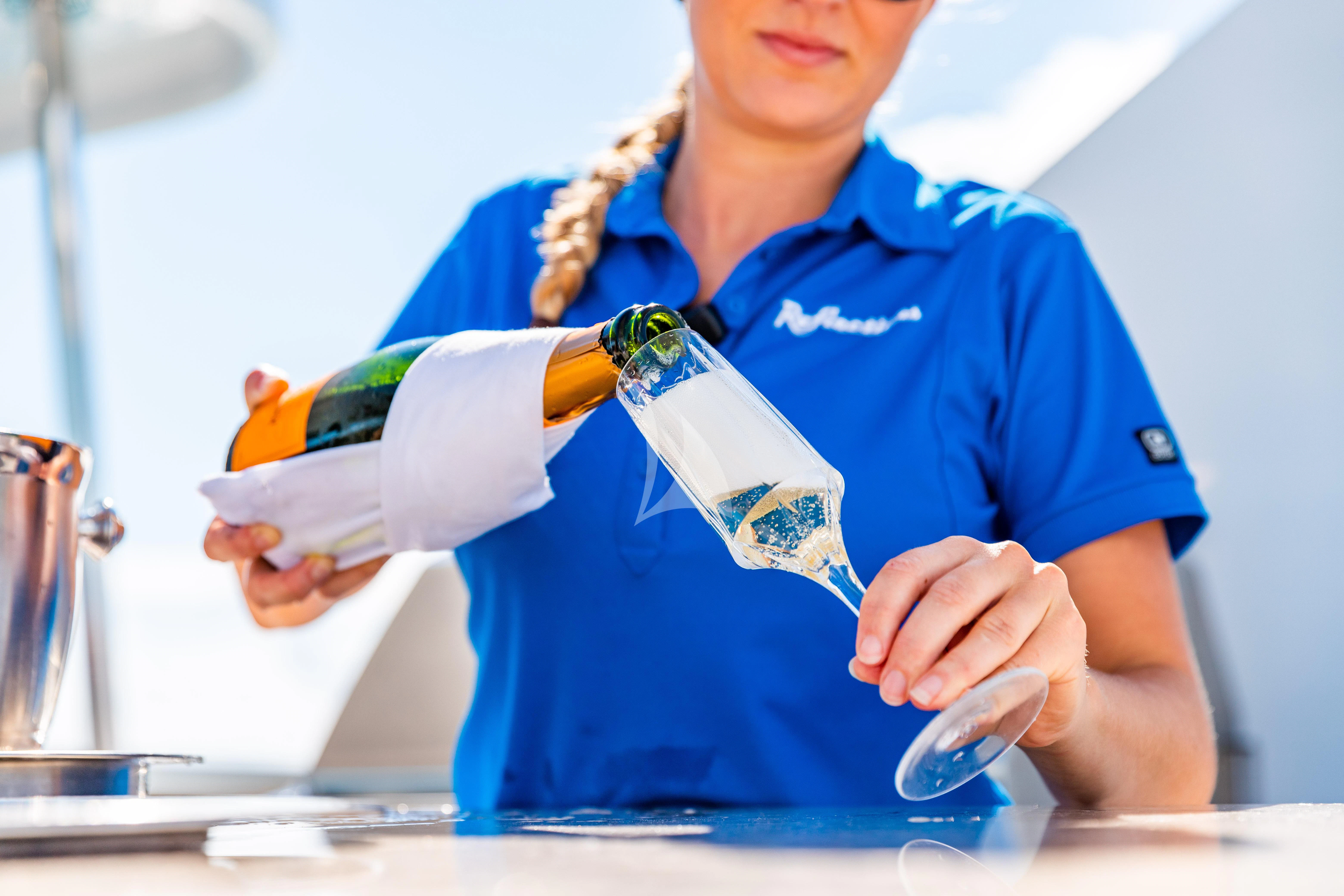 a person wearing a blue apron aboard SEAQUEST Yacht for Sale