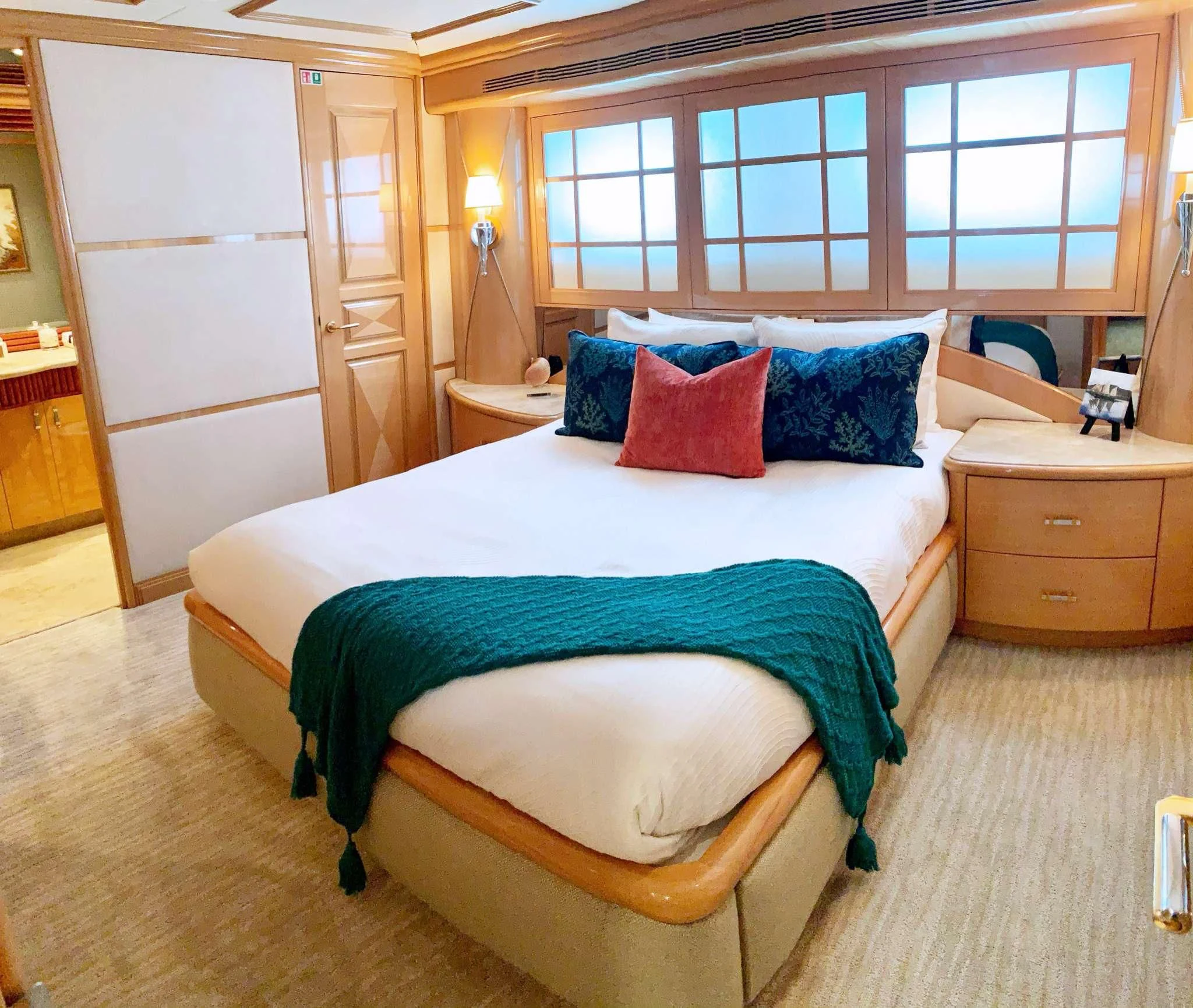 a bed with blue and green sheets aboard SEAQUEST Yacht for Sale