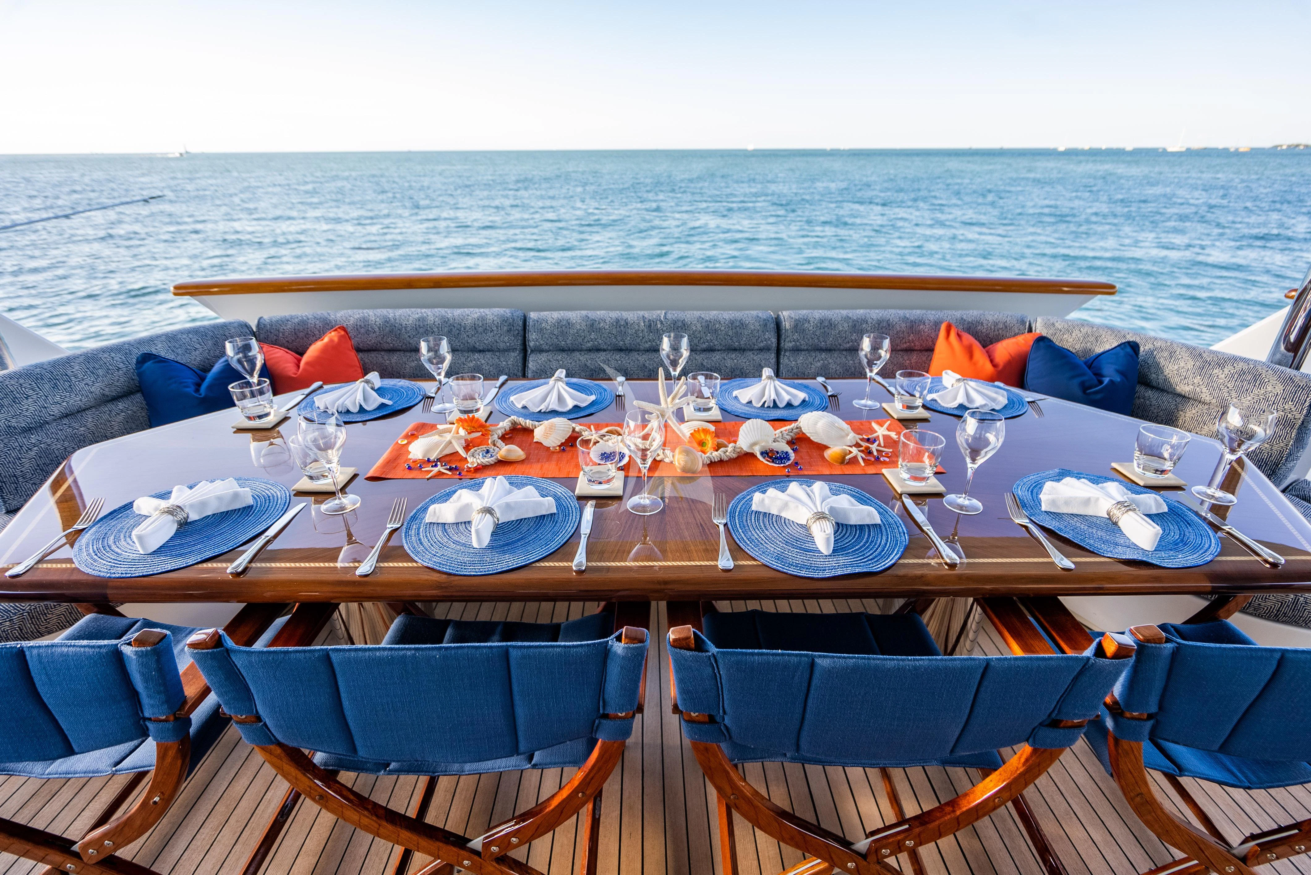 a table with chairs on it by the water aboard SEAQUEST Yacht for Sale