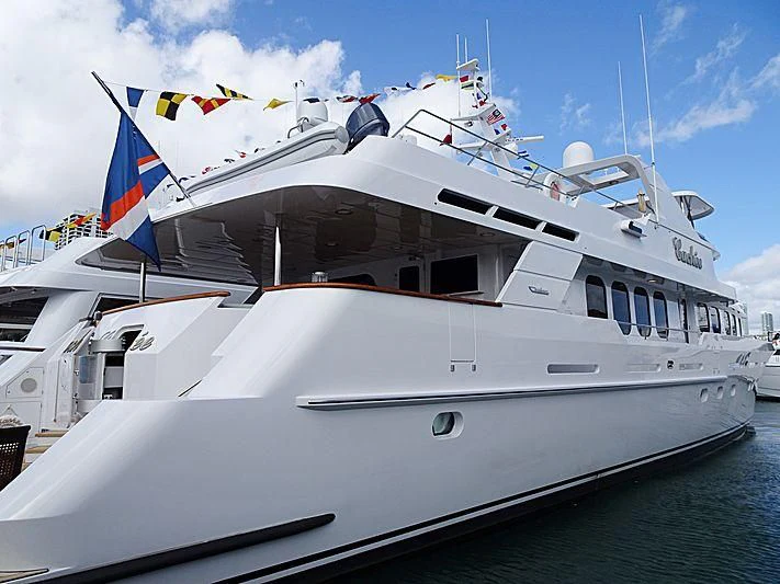 a large white boat with flags on it aboard SEAQUEST Yacht for Sale
