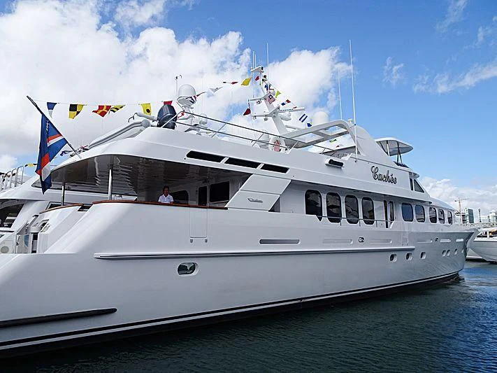 a large white boat with flags on it aboard SEAQUEST Yacht for Sale