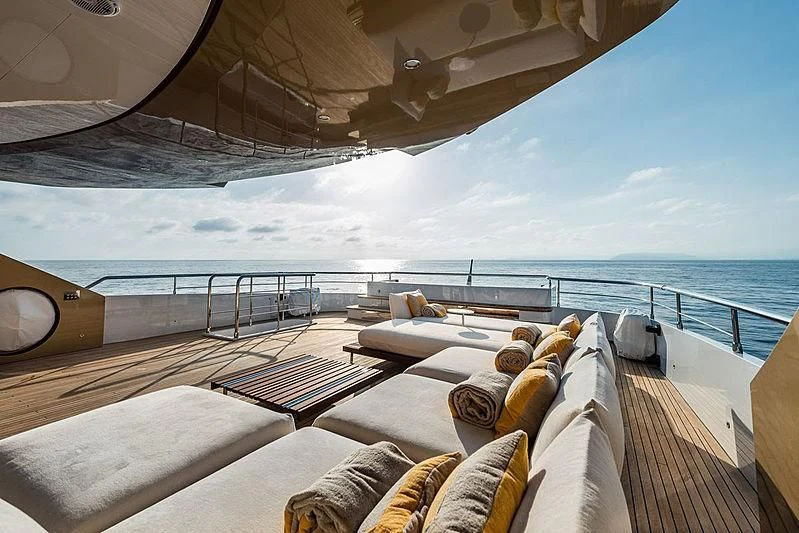 a deck with a view of the ocean and the ocean aboard KIMOJO Yacht for Sale