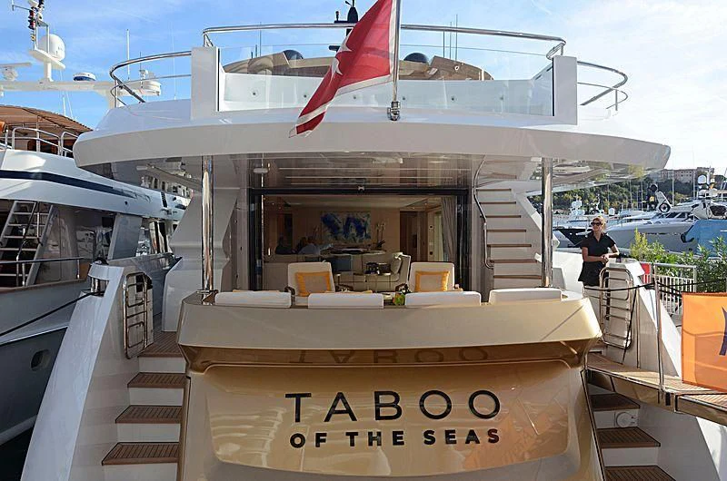 a boat with a flag on the front aboard KIMOJO Yacht for Sale