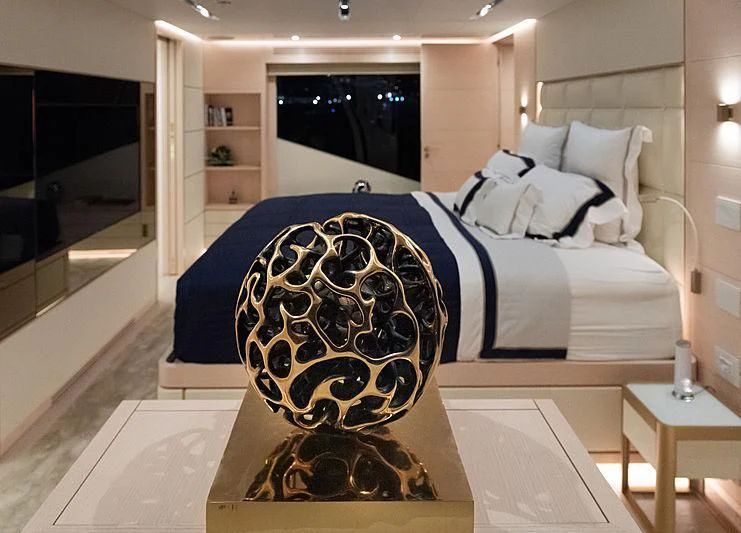 a bed with a blue and white bed spread aboard KIMOJO Yacht for Sale