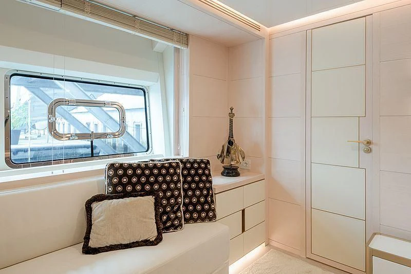 a room with a chair and a window aboard KIMOJO Yacht for Sale