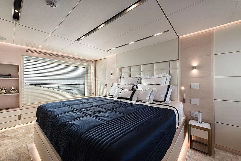a bedroom with a bed and a window aboard KIMOJO Yacht for Sale