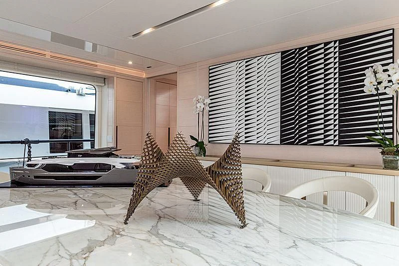 a room with a couch and a table and chairs aboard KIMOJO Yacht for Sale