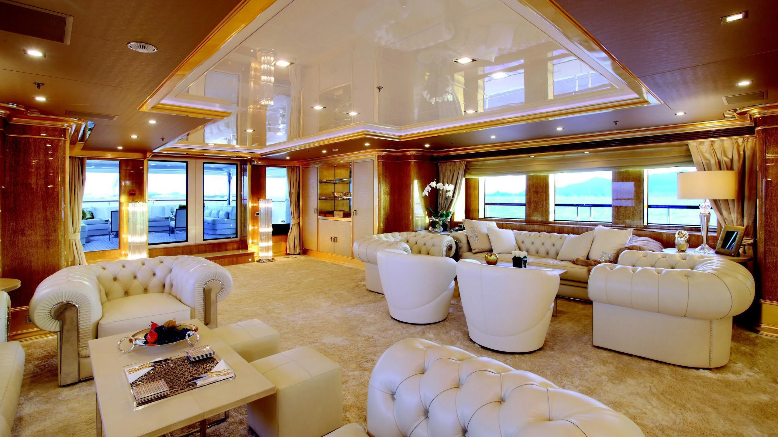 a large living room with a large window aboard MONARCH Yacht for Sale