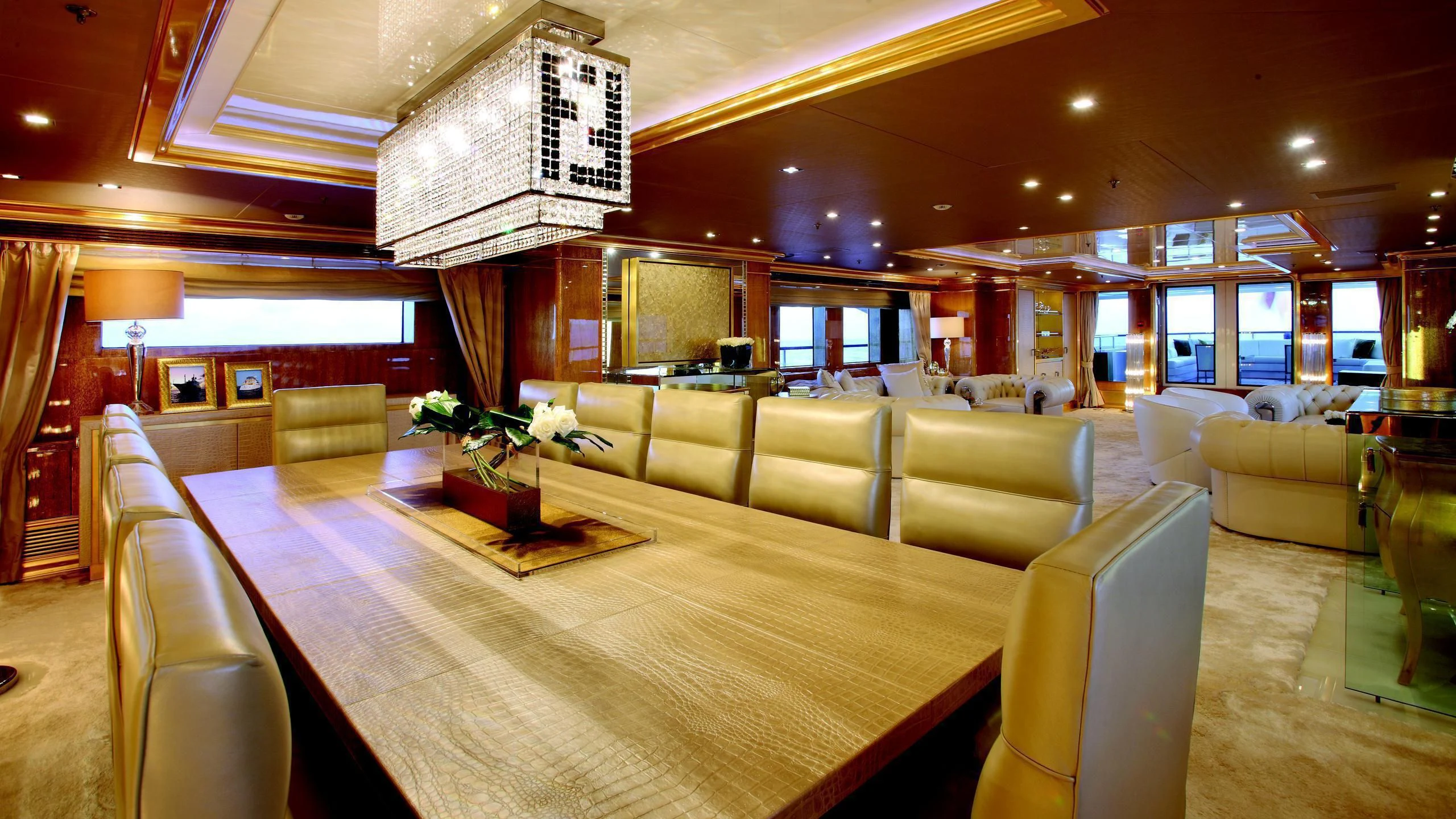 a large room with a table and chairs aboard MONARCH Yacht for Sale