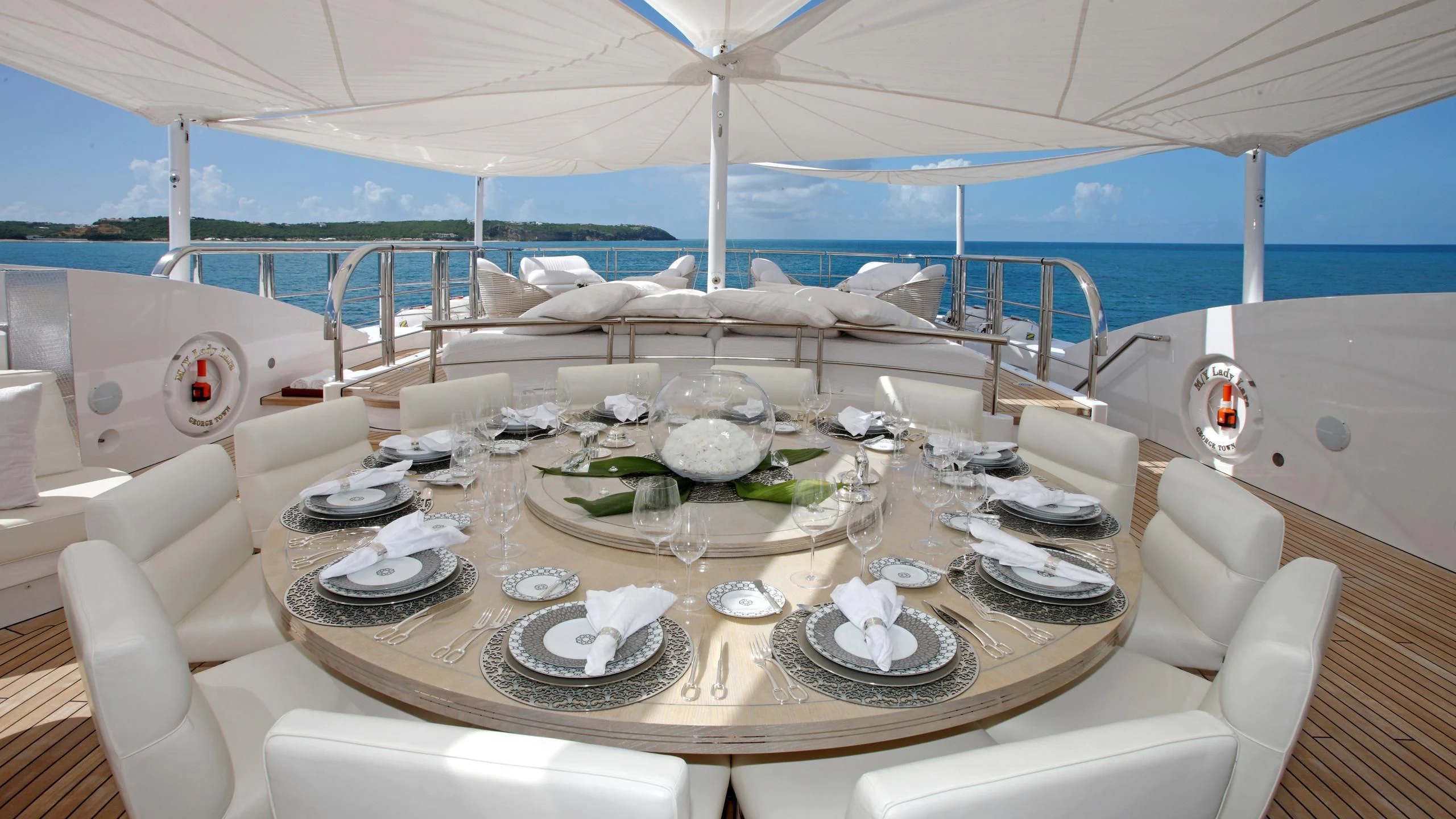 a table with plates and glasses on it aboard MONARCH Yacht for Sale
