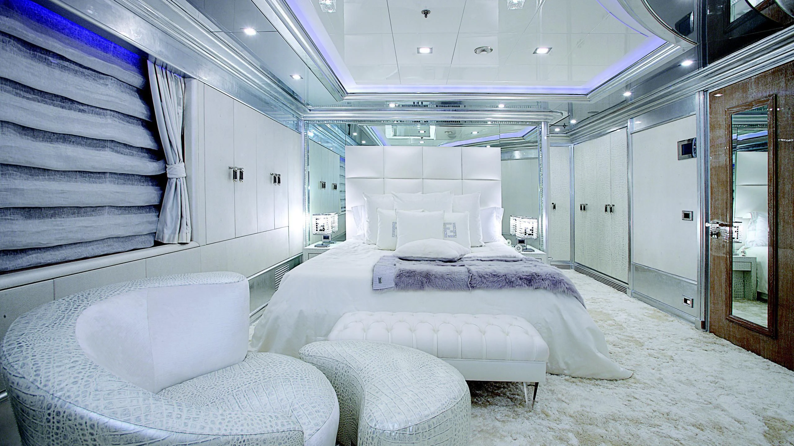 a room with a bed and a chair aboard MONARCH Yacht for Sale