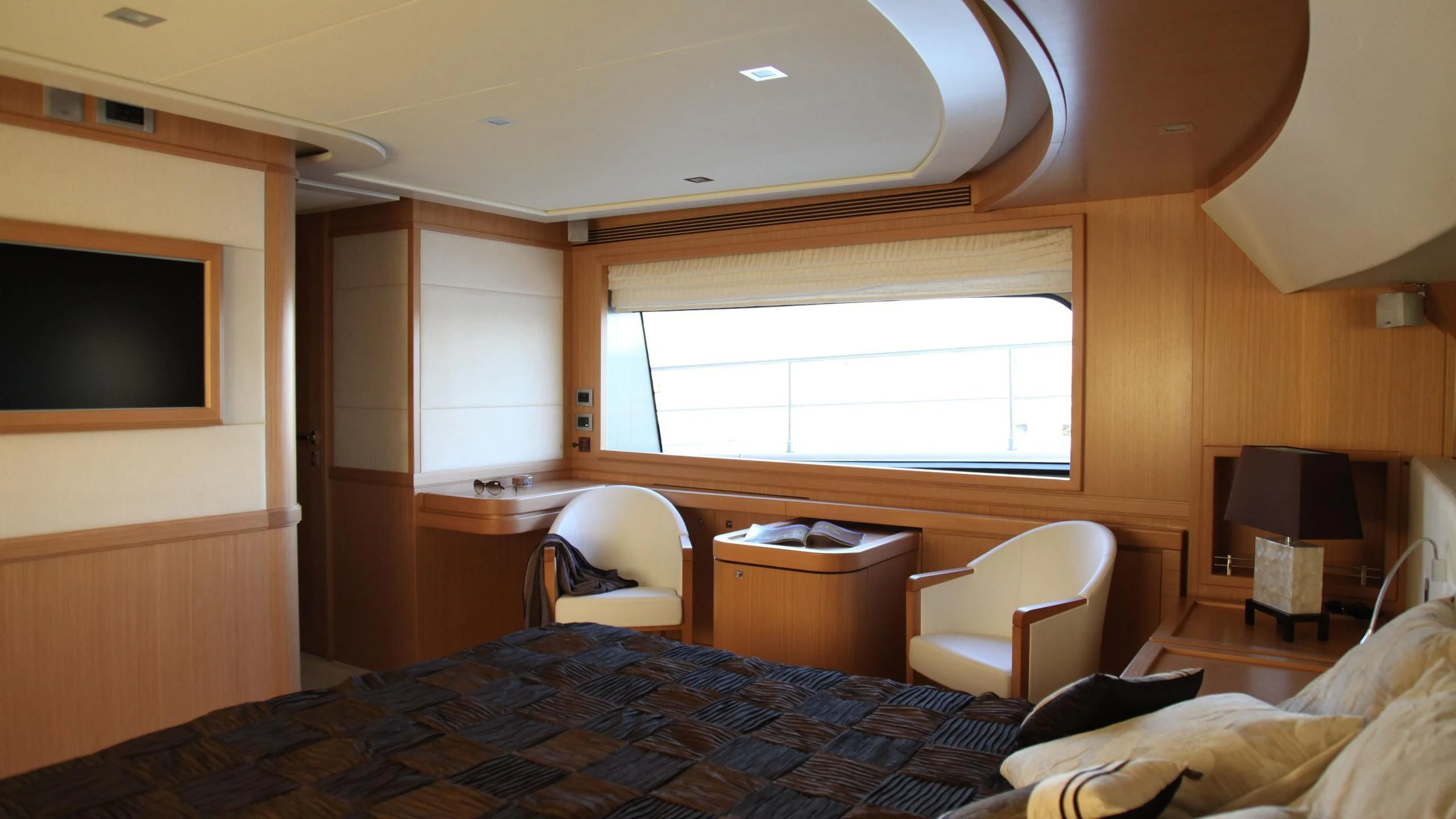 a bedroom with a bed and a tv aboard ULYSSIA Yacht for Sale
