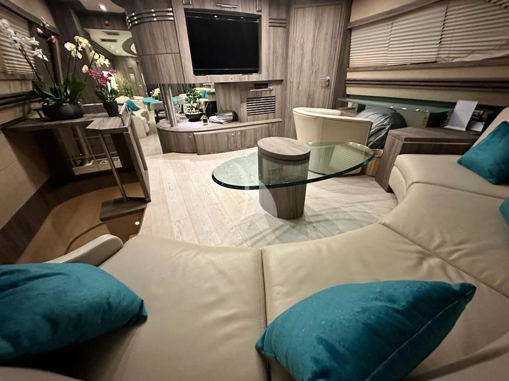 a living room with a couch and a television aboard LADY B Yacht for Charter