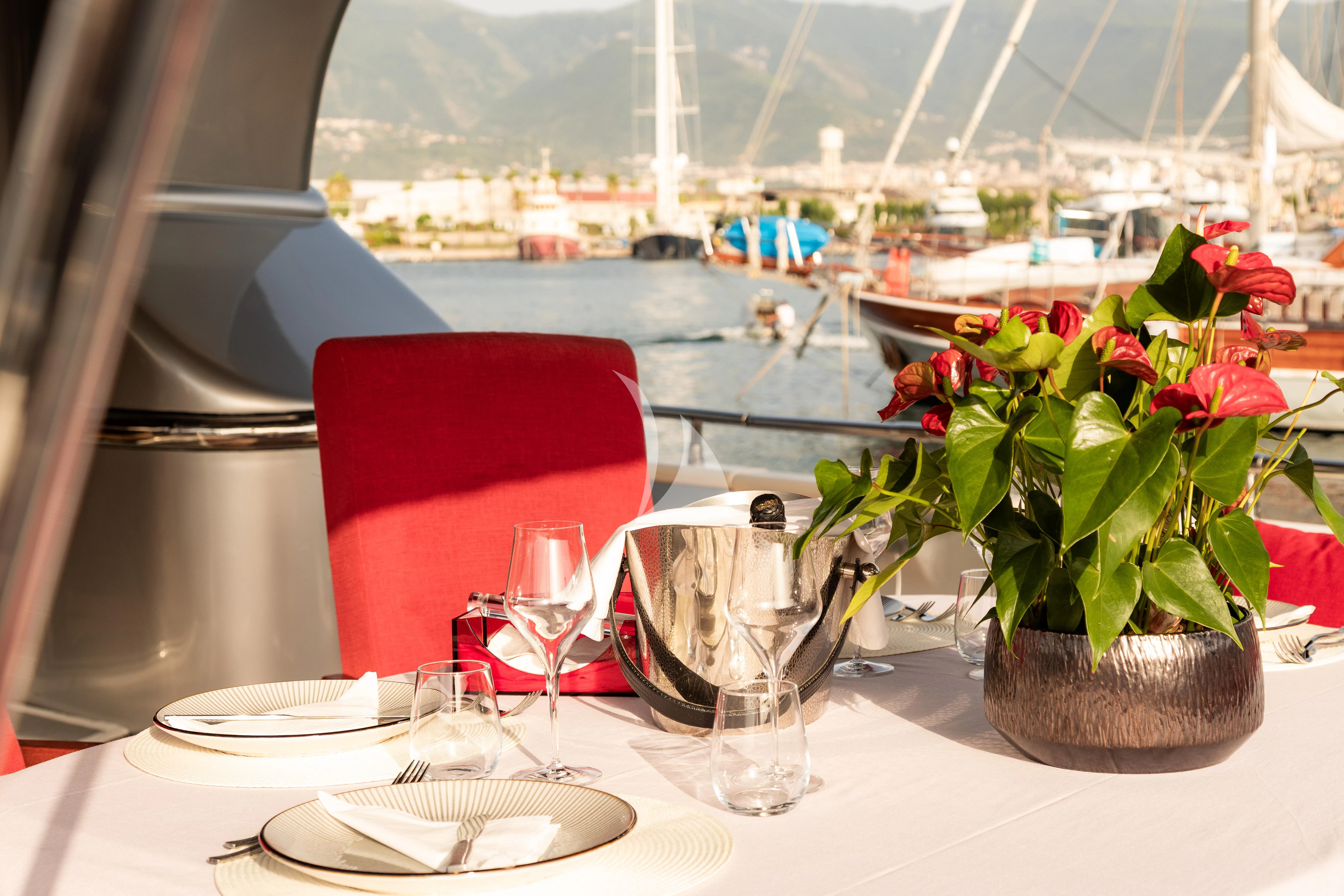 a table with plates and glasses on it aboard LADY B Yacht for Charter