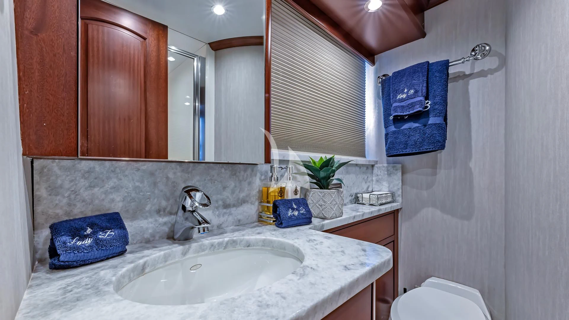 a bathroom with a sink and a mirror aboard LADY B Yacht for Charter