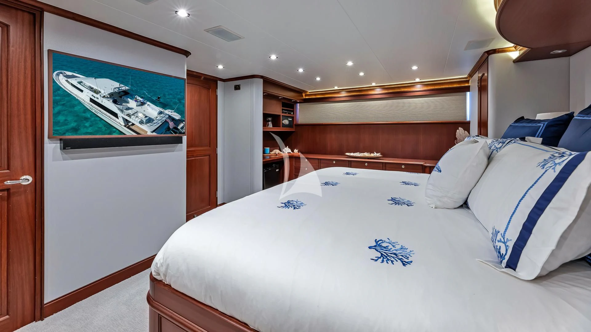 a room with a bed and a wood door aboard LADY B Yacht for Charter