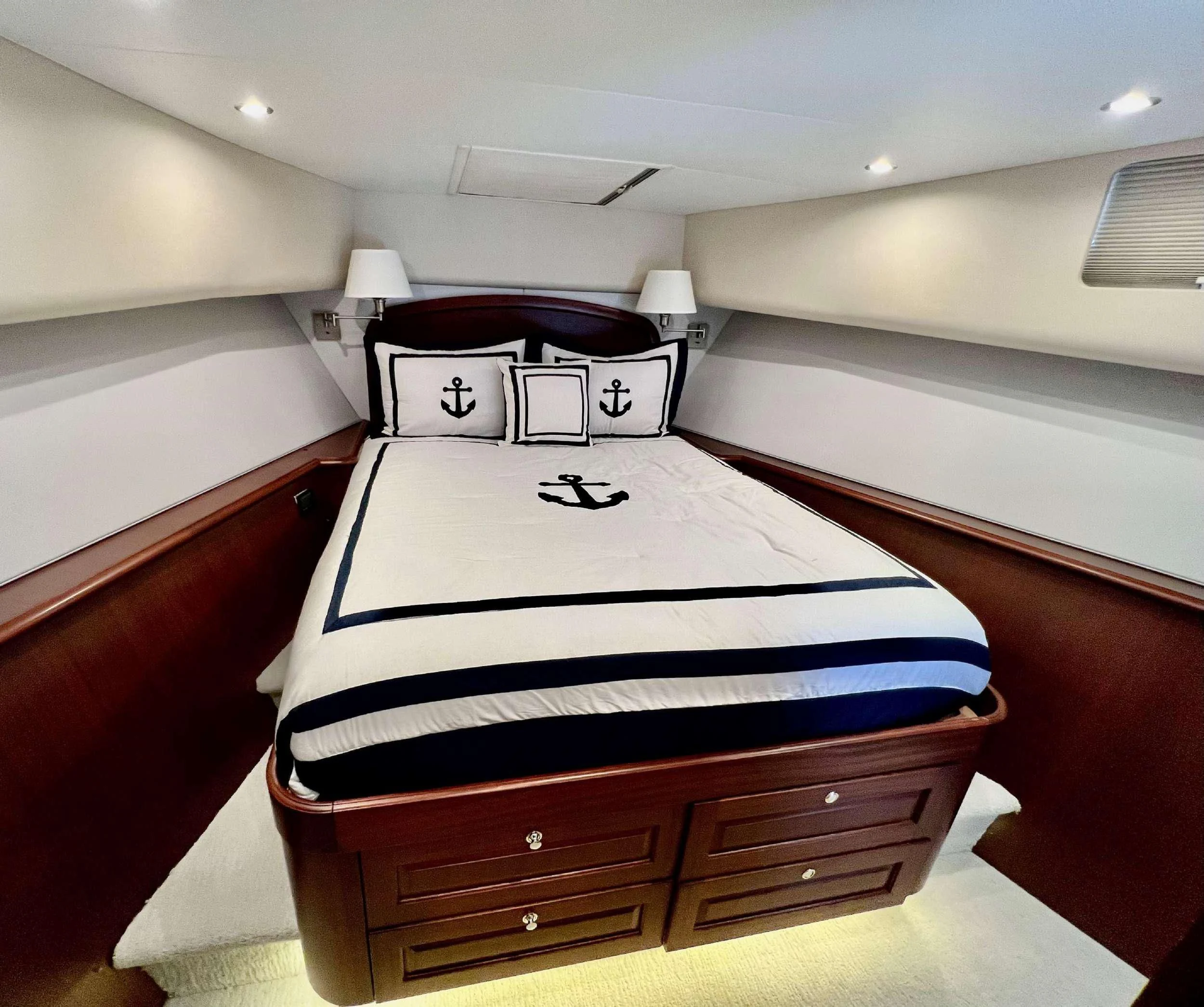 a bed with a white sheet on it aboard LADY B Yacht for Charter