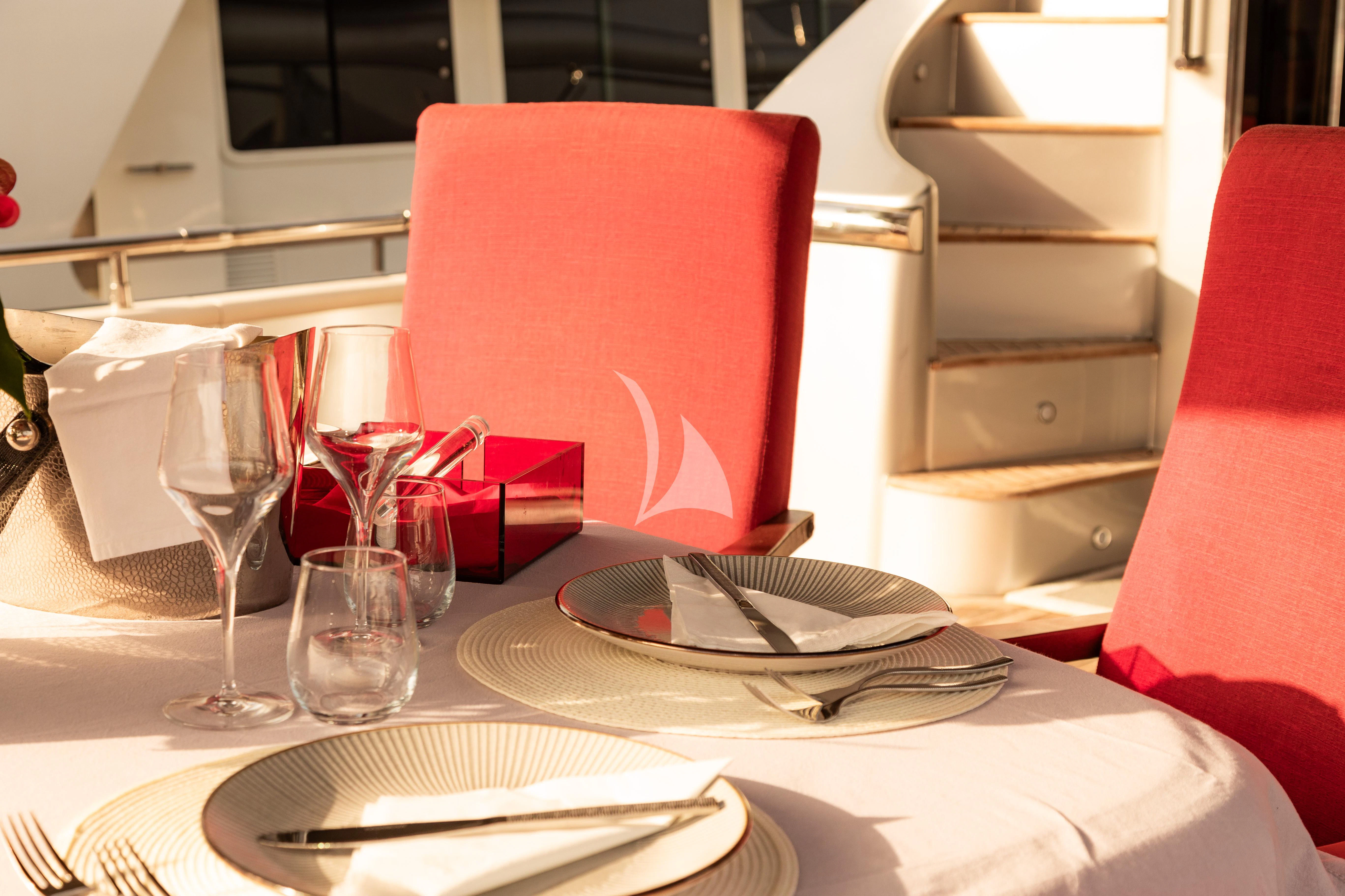 a table with plates and glasses aboard LADY B Yacht for Charter