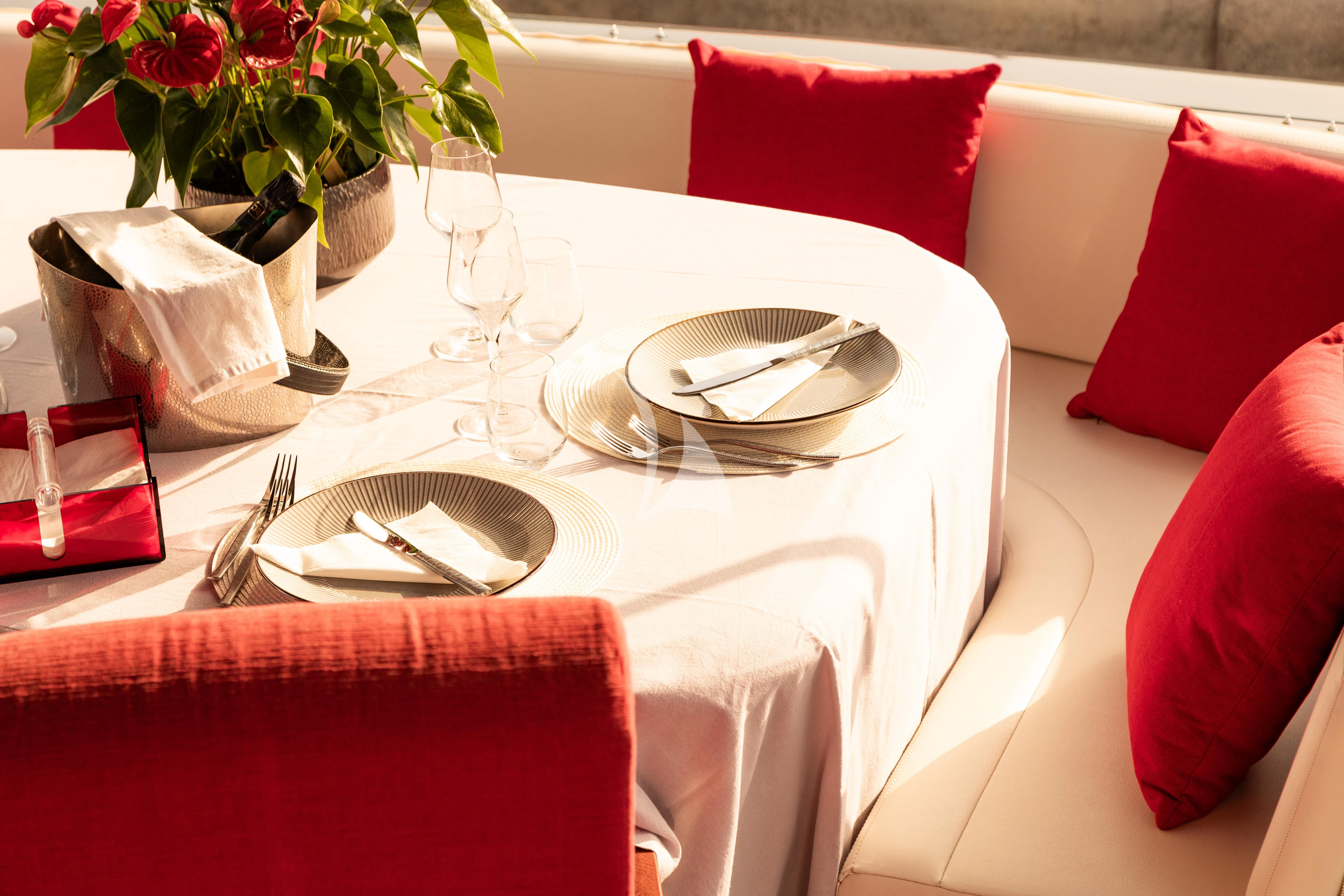 a table set with place settings aboard LADY B Yacht for Charter