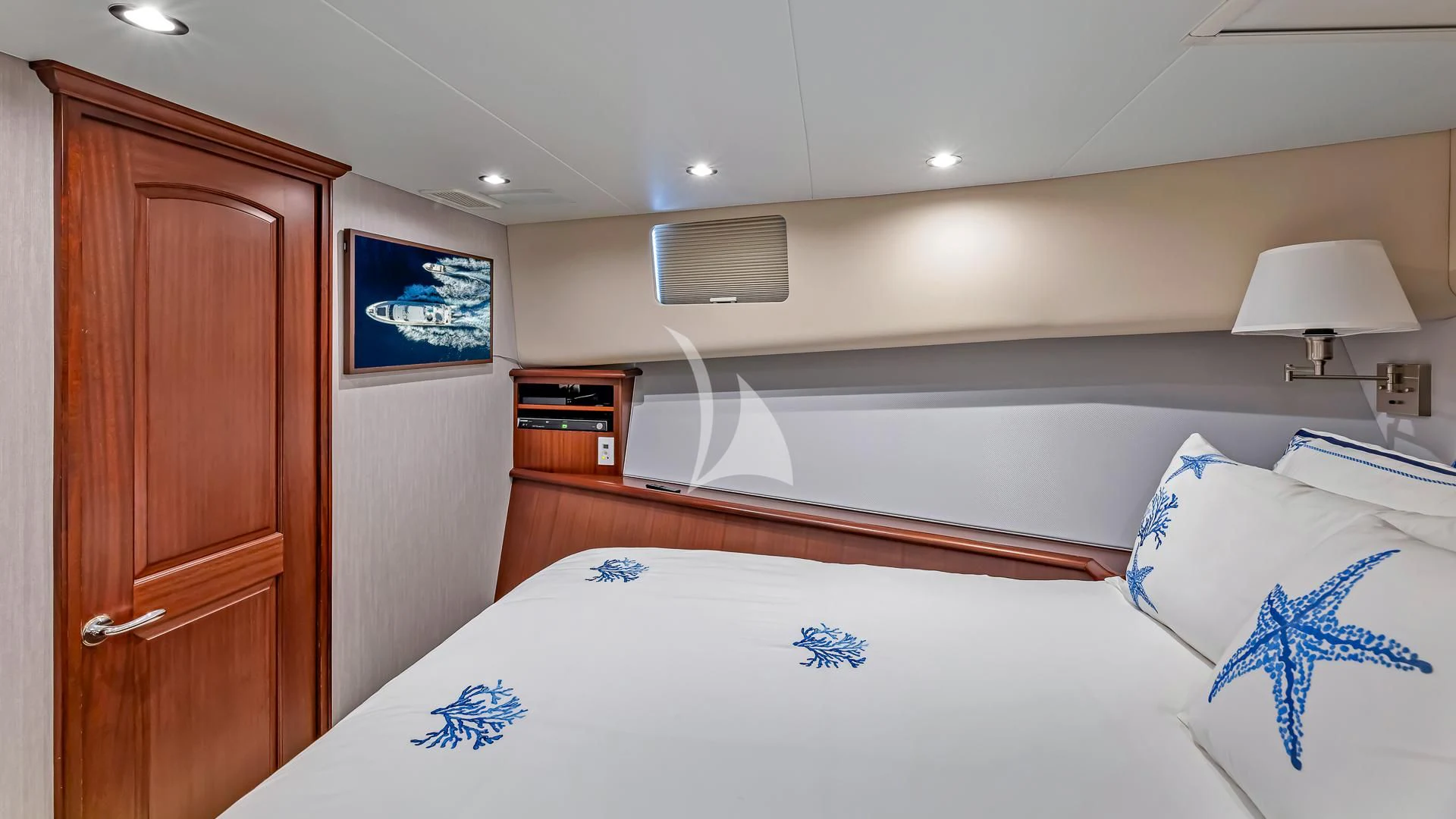 a bedroom with a bed and a desk aboard LADY B Yacht for Charter