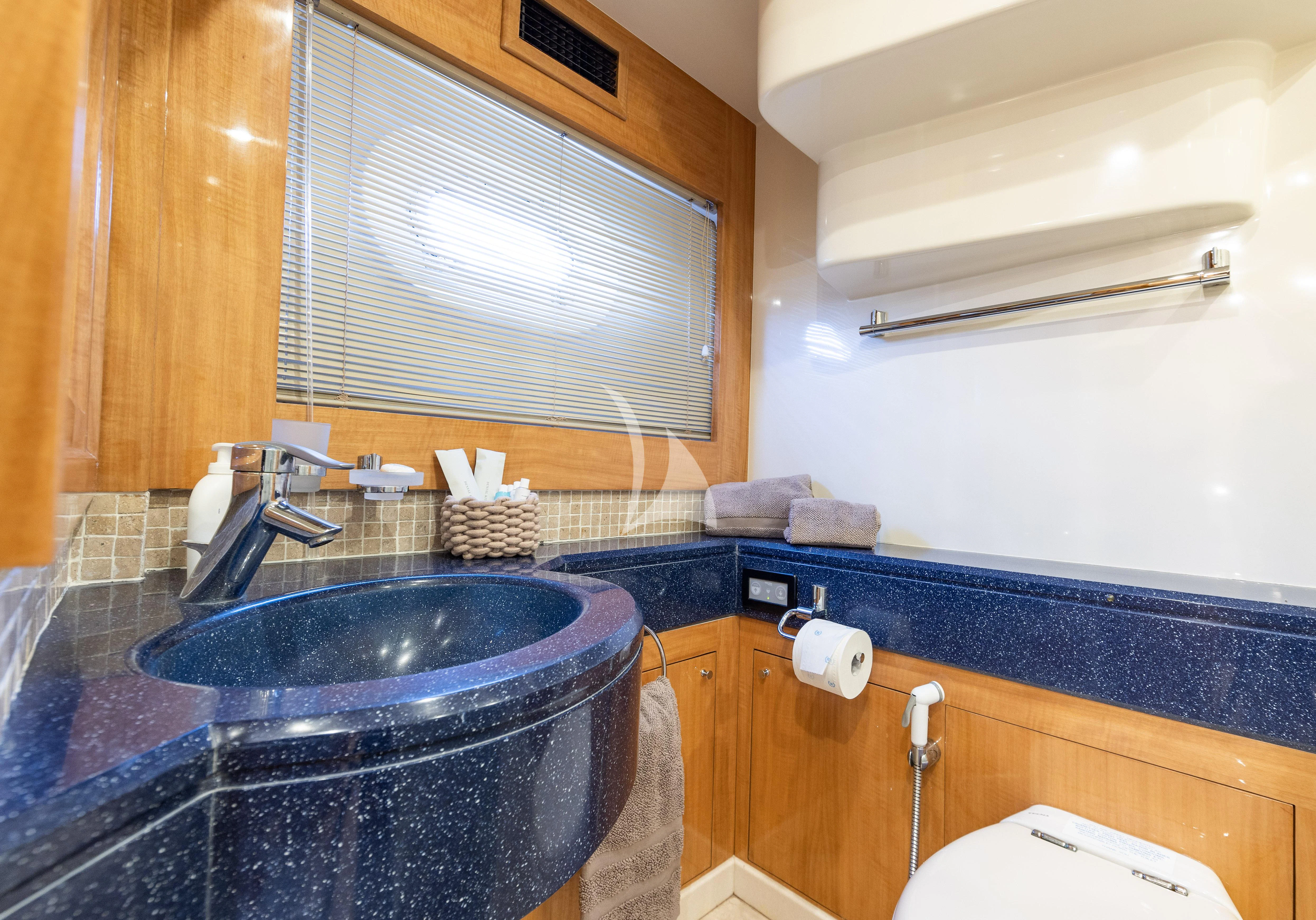 a bathroom with a sink and a window aboard LADY B Yacht for Charter