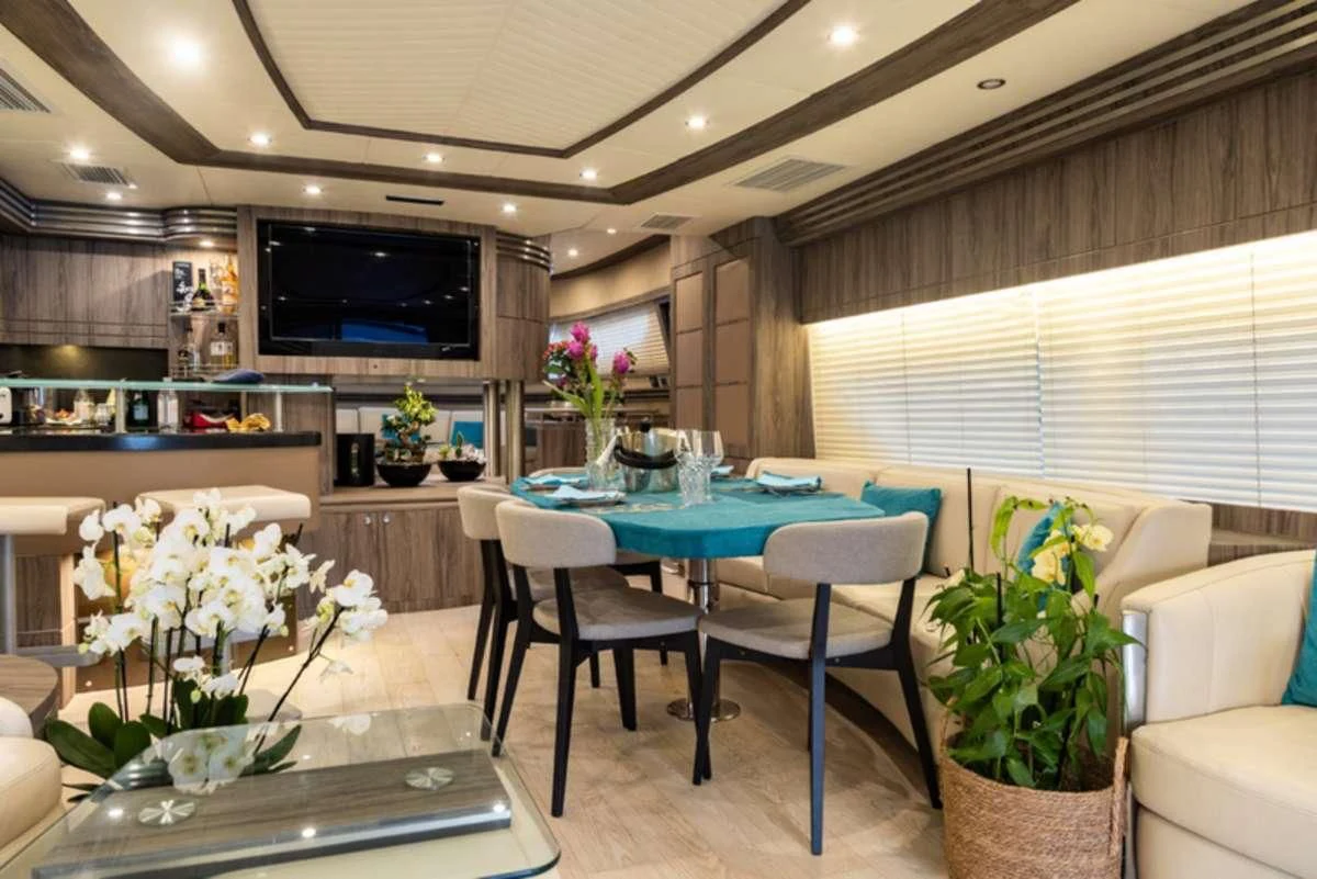 a living room with a table and chairs aboard LADY B Yacht for Charter