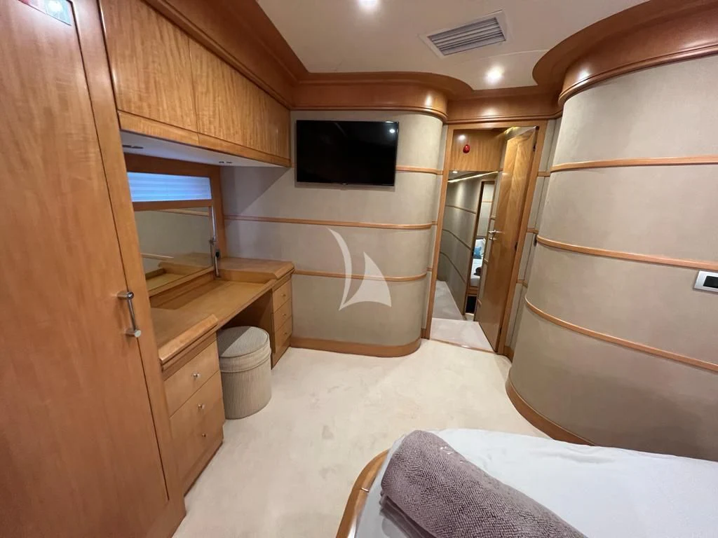 a bathroom with a bed and a television aboard LADY B Yacht for Charter