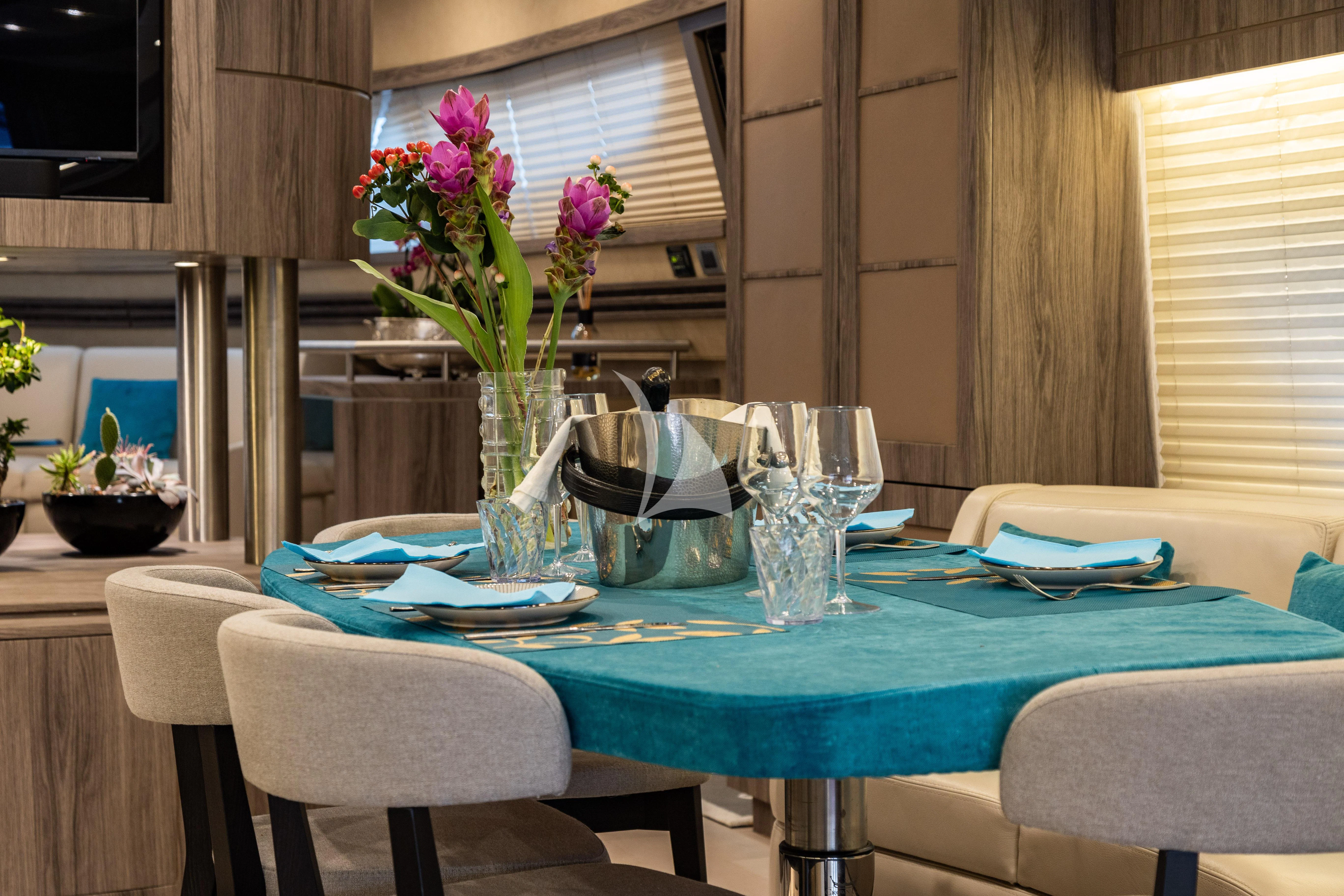 a table with plates and glasses on it aboard LADY B Yacht for Charter
