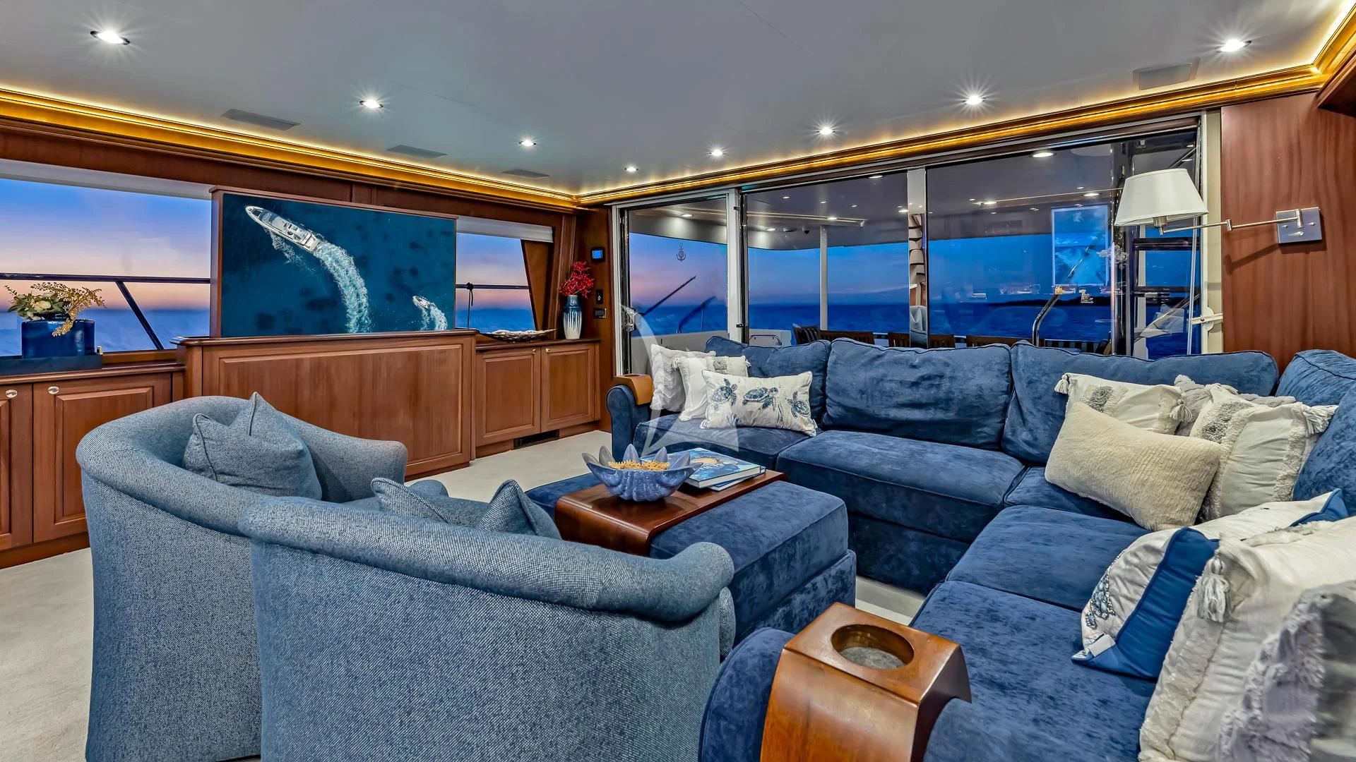 a living room with a blue couch aboard LADY B Yacht for Charter