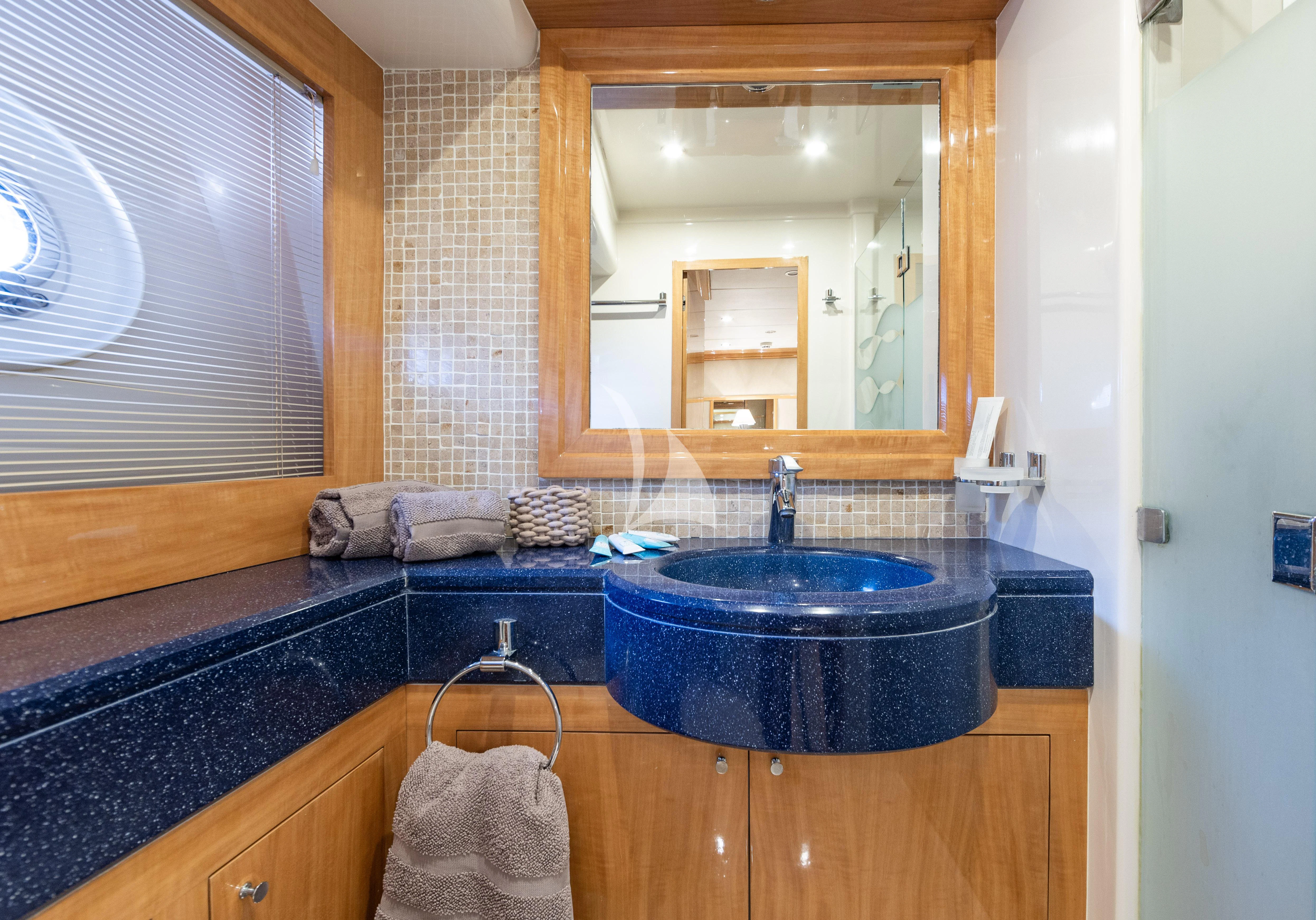 a bathroom with a sink and mirror aboard LADY B Yacht for Charter