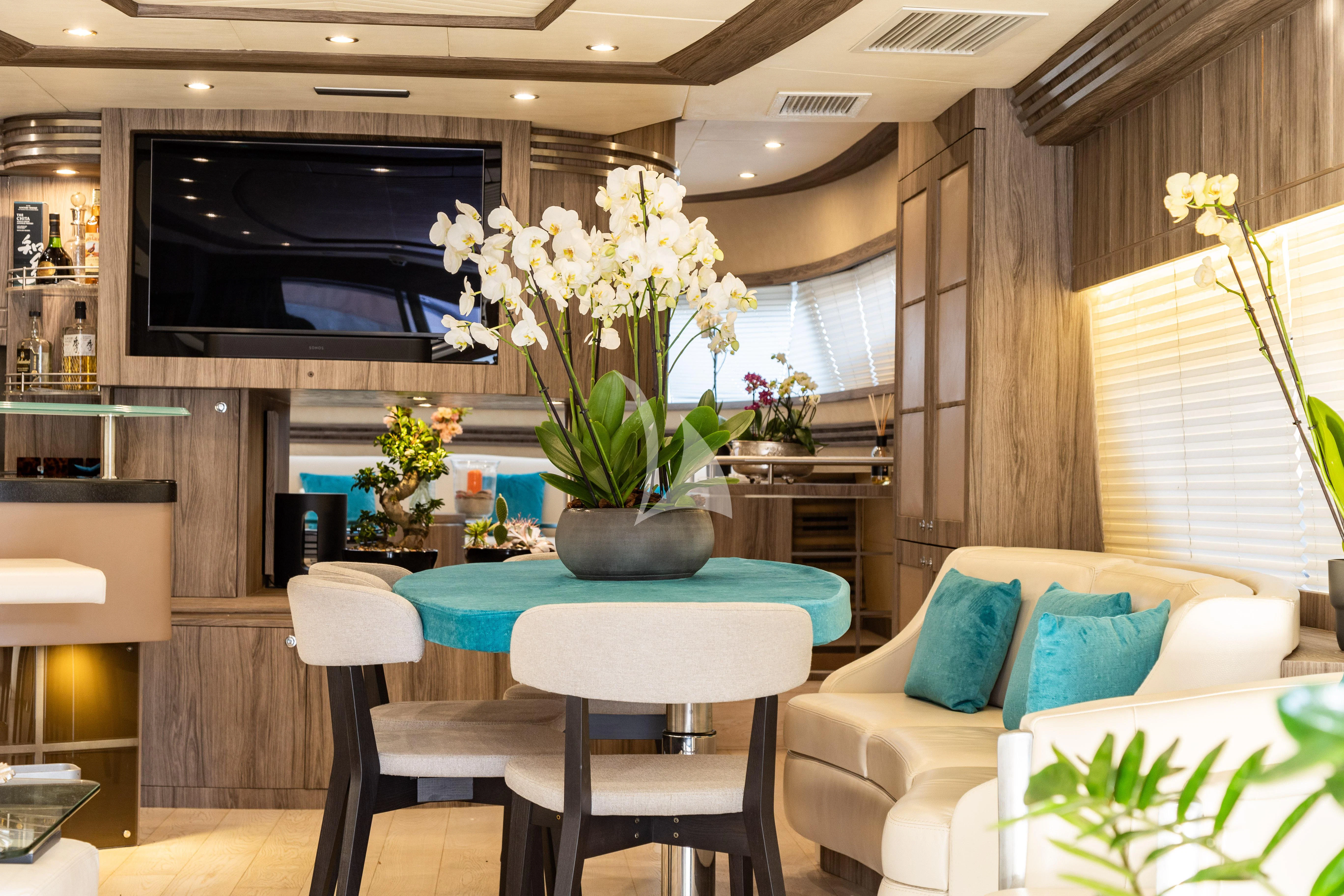 a living room with a table and chairs aboard LADY B Yacht for Charter