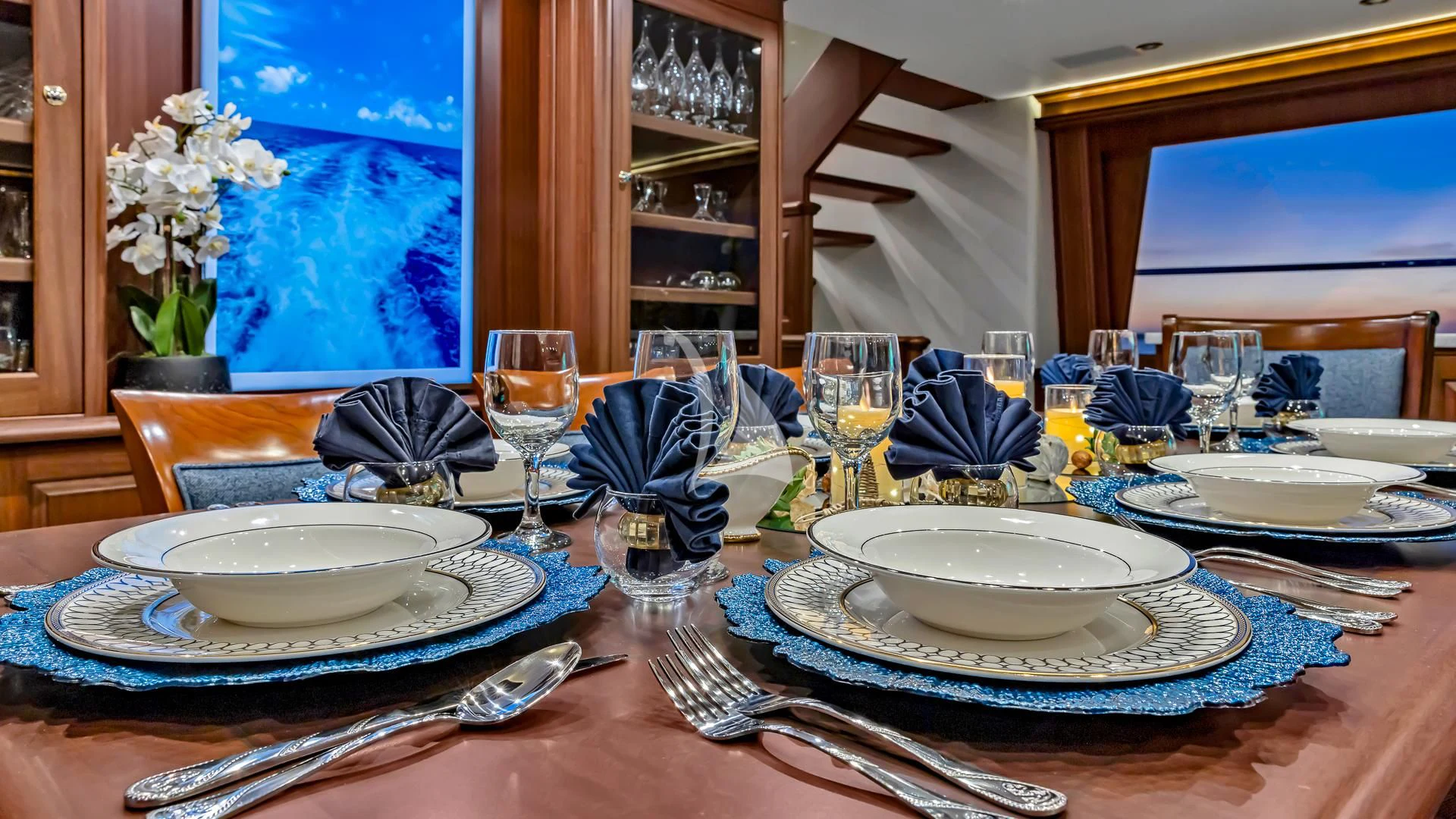 a table with plates and glasses aboard LADY B Yacht for Charter