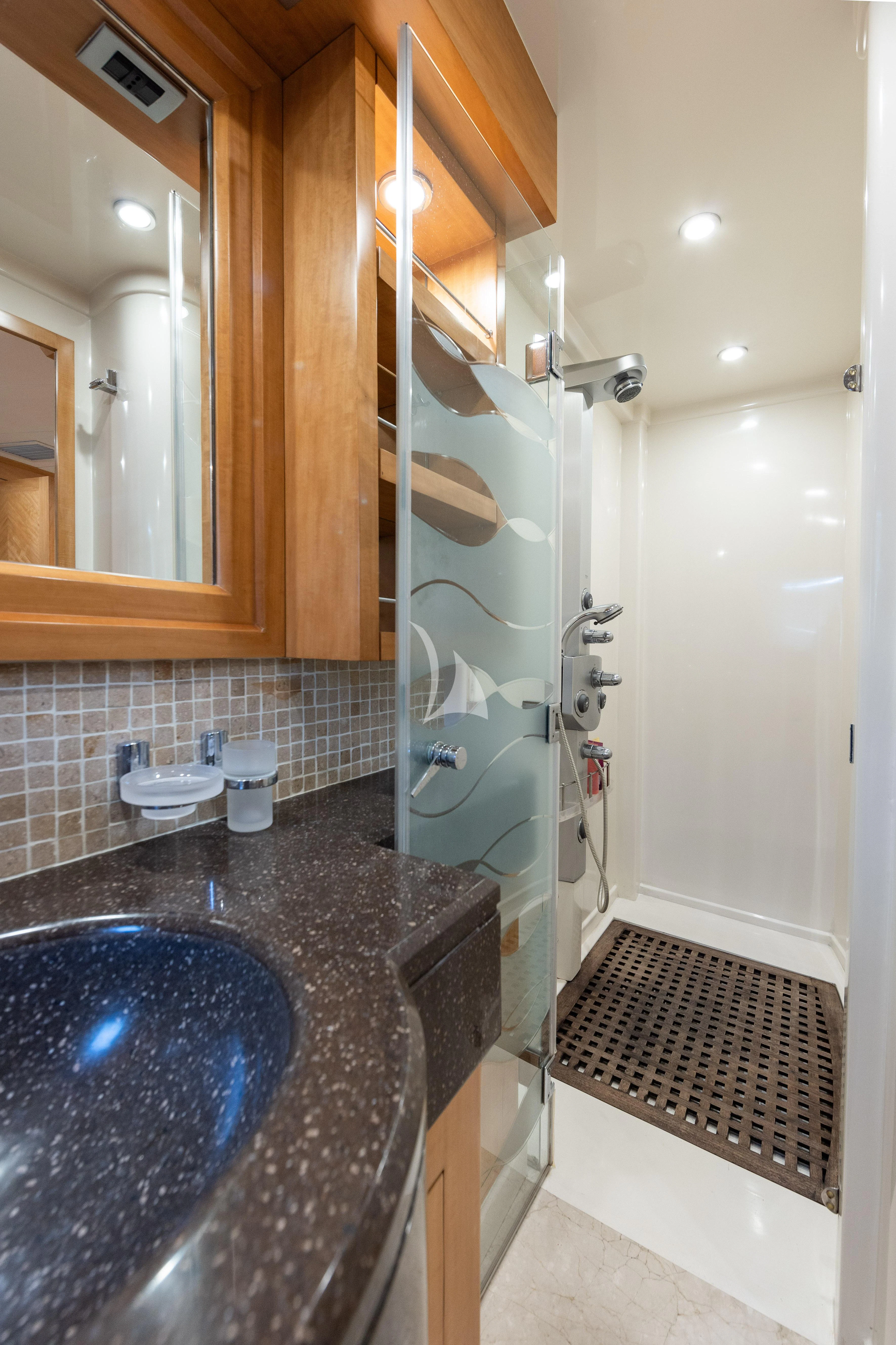 a bathroom with a sink and a shower aboard LADY B Yacht for Charter