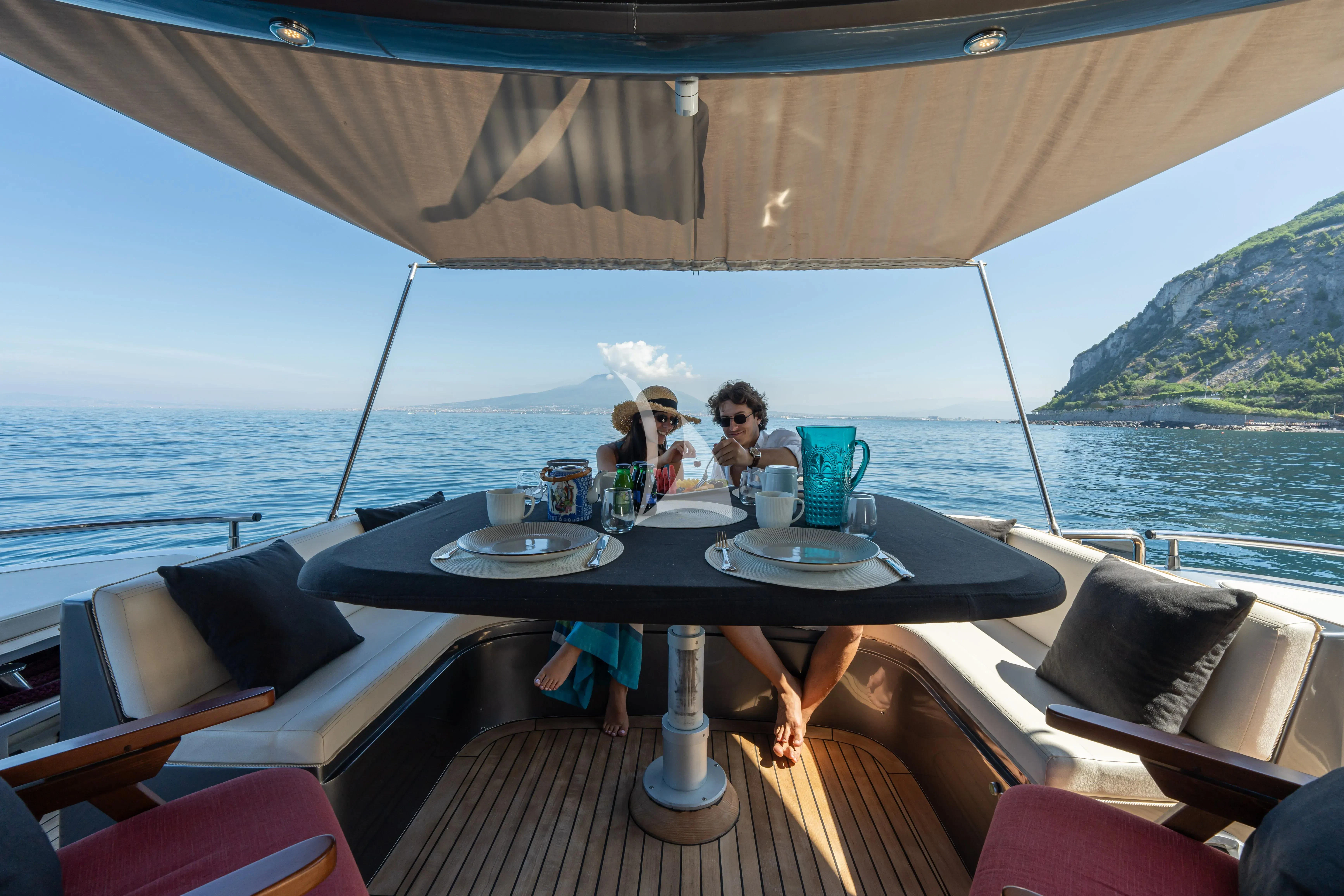 a couple of people sitting at a table on a boat aboard LADY B Yacht for Charter