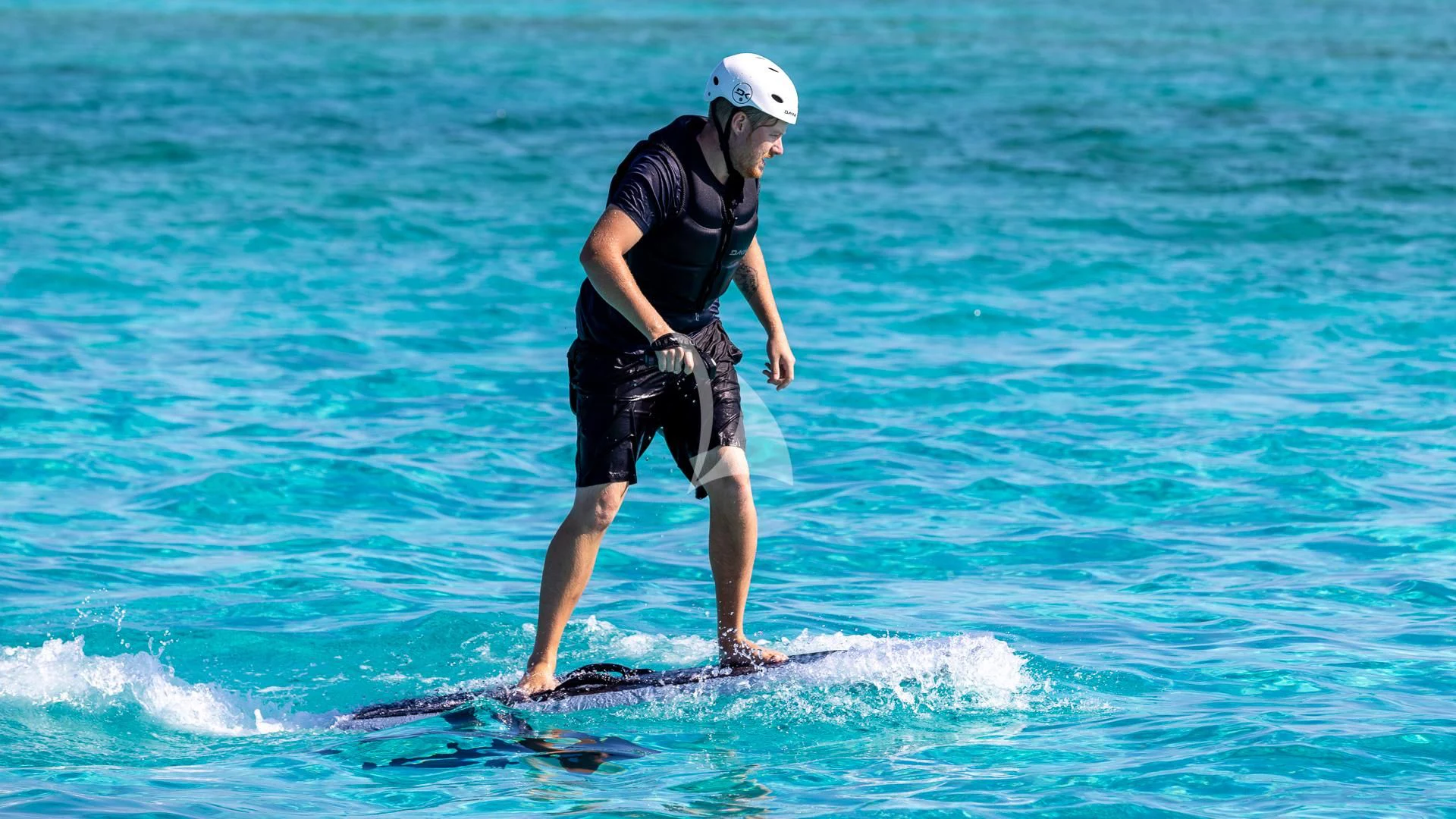a man is surfing in the sea aboard LADY B Yacht for Charter