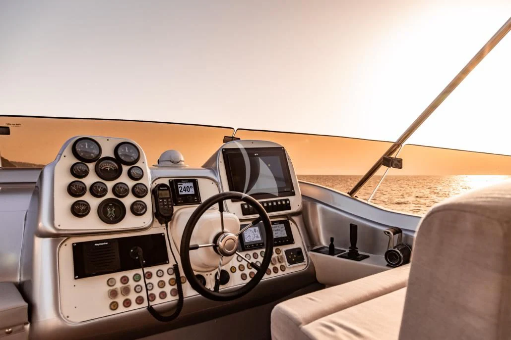 a person driving a car aboard LADY B Yacht for Charter