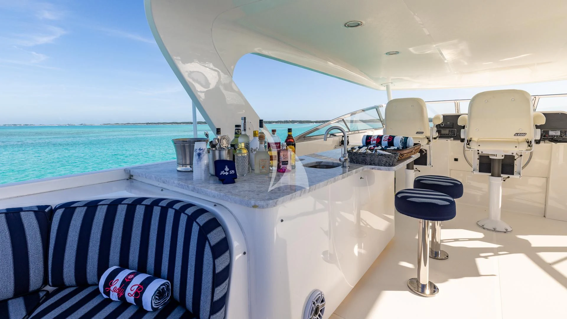 a white table with chairs and a view of the ocean aboard LADY B Yacht for Charter