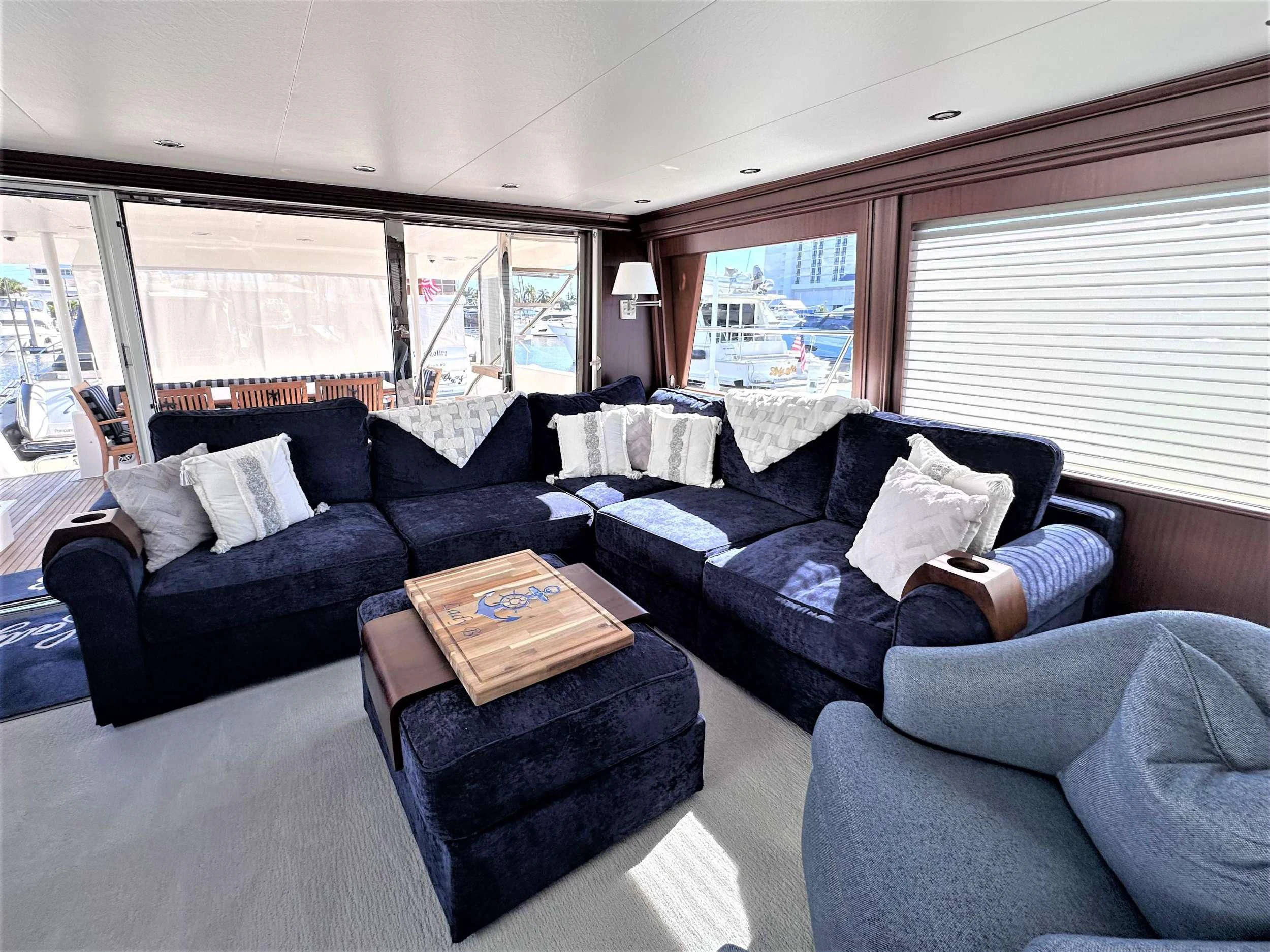 a living room with a couch and a coffee table aboard LADY B Yacht for Charter