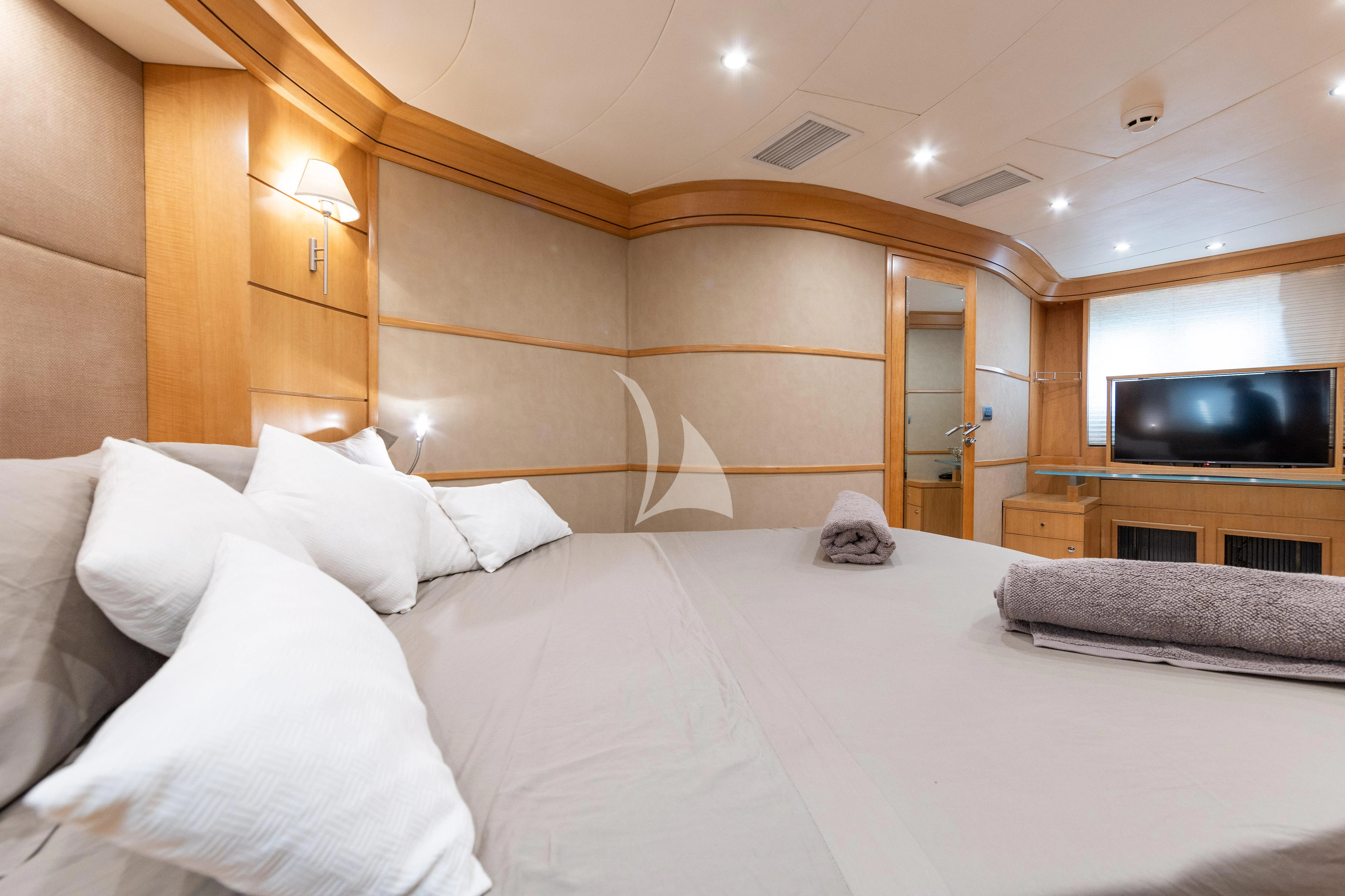 a bed with white sheets aboard LADY B Yacht for Charter