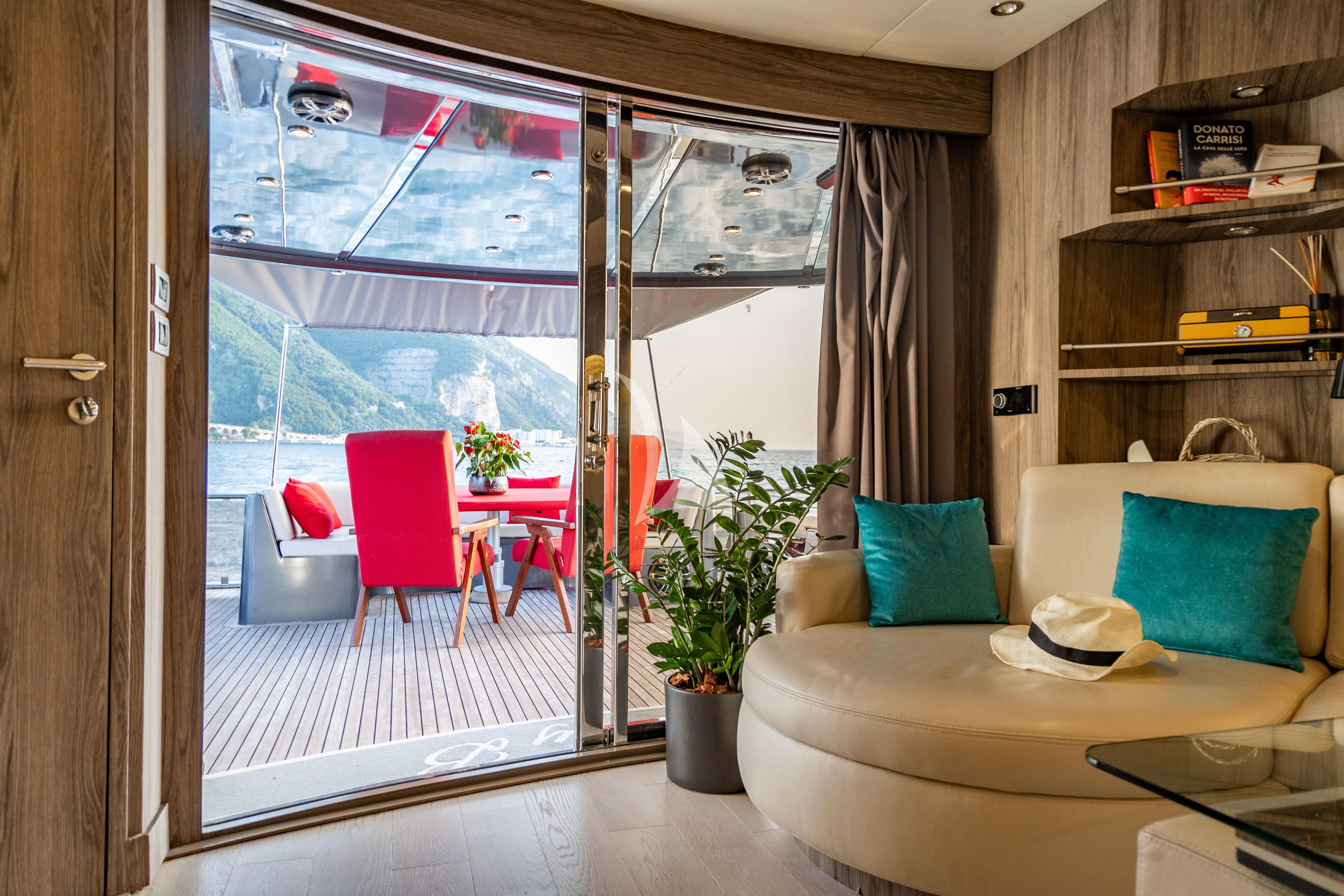 a room with a couch and a table and a window aboard LADY B Yacht for Charter