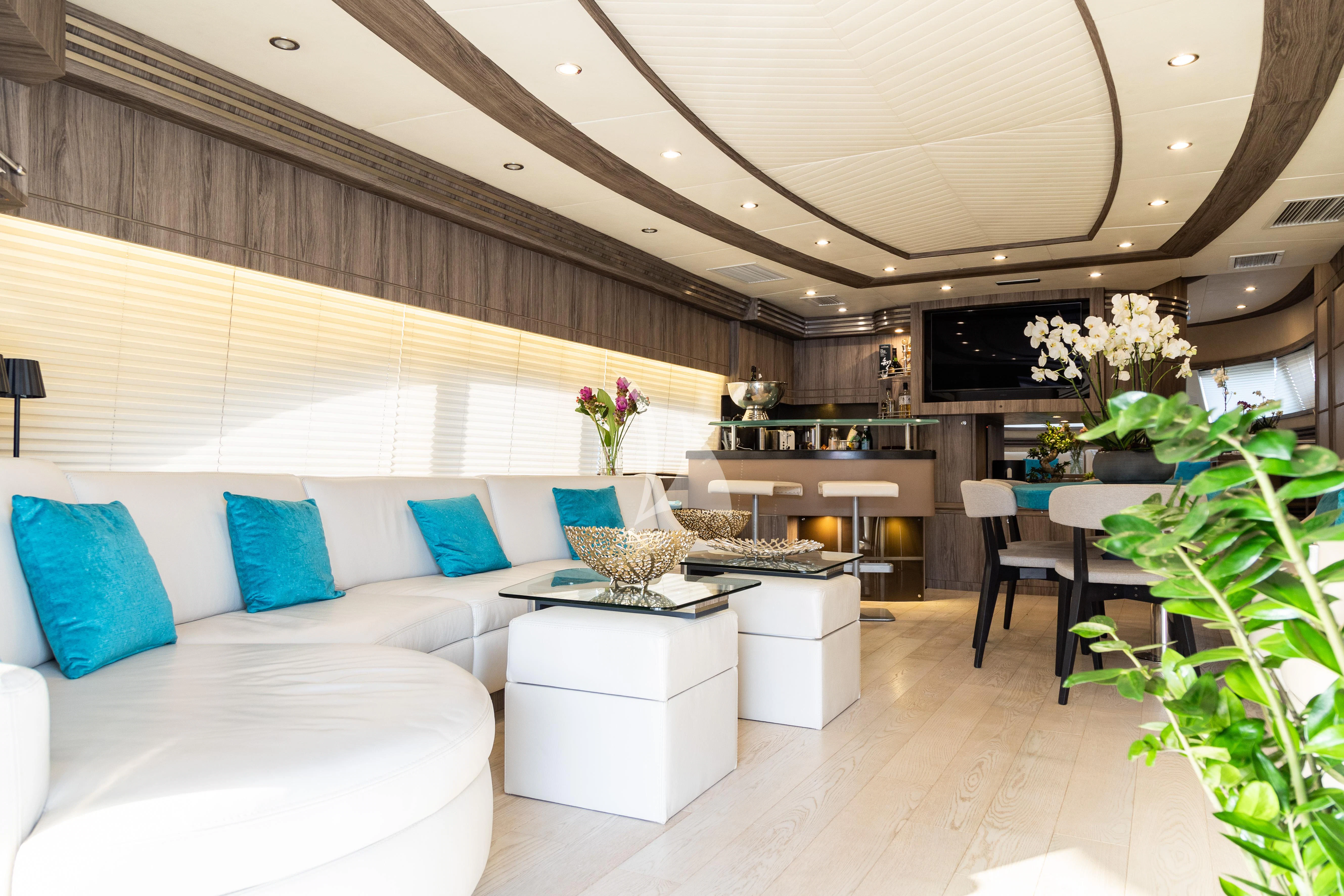 a modern living room with white furniture aboard LADY B Yacht for Charter